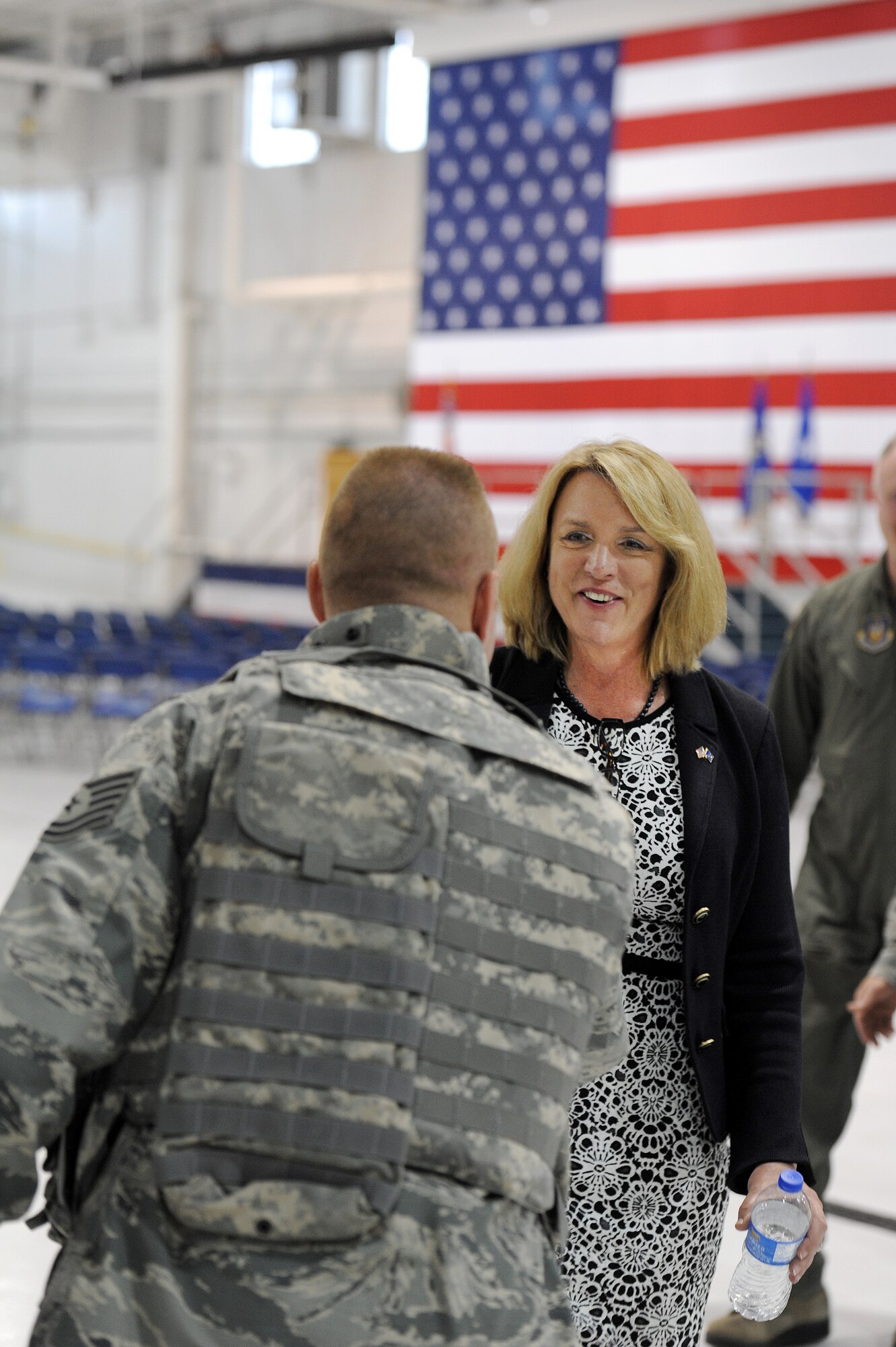 Secretary of the Air Force Deborah Lee James shakes hands with Tech Sgt. Travis Patterson, 442nd Security Forces Squadron unit training manager during her visit to Whiteman Air Force Base, Mo., May 29, 2014. James visited different active duty, Guard and Reserve units on base. (U.S. Air Force photo by Staff Sgt. Nicholas Wilson/Released)