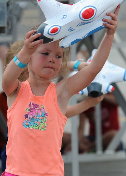 A child plays with a Thunderbird souvenir during SkyFest 2014 at Fairchild Air Force Base, Wash., June 1, 2014. SkyFest is Fairchild’s air show and open house, giving the local and regional community the opportunity to view Airmen and our resources. The event typically draws more than 150,000 people. SkyFest 2008, headlined by the Blue Angels, was the largest event held in Spokane since the 1974 World’s Fair. (U.S. Air Force photo by Airman 1st Class Janelle Patiño/Released)