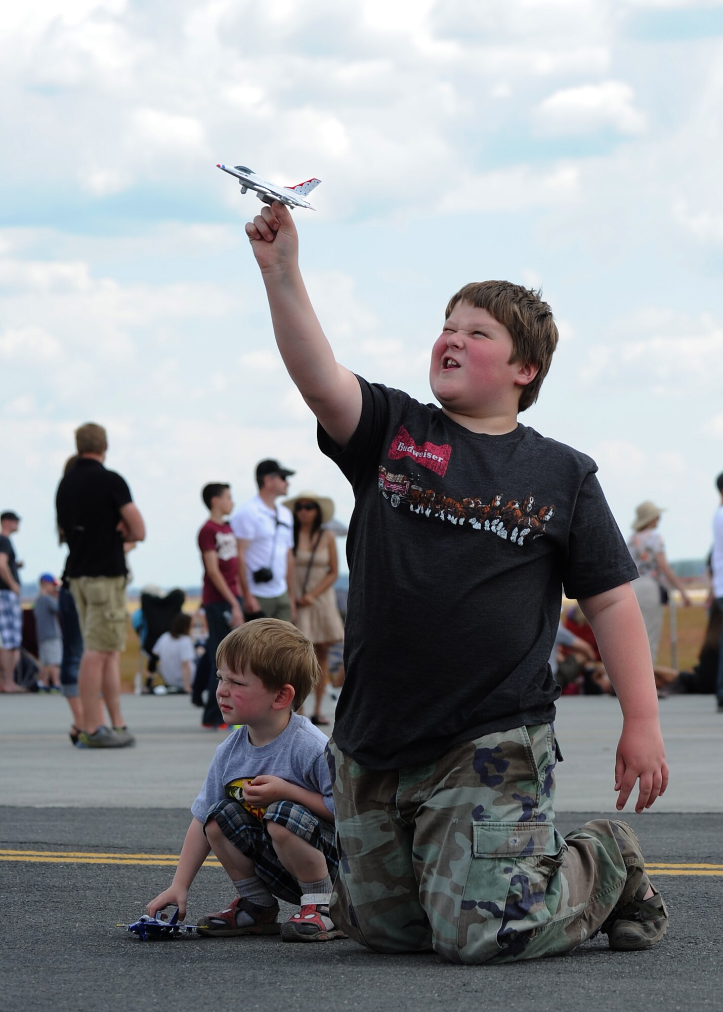 A child plays with a Thunderbird souvenir during SkyFest 2014 at Fairchild Air Force Base, Wash., June 1, 2014. SkyFest is Fairchild’s air show and open house, giving the local and regional community the opportunity to view Airmen and our resources. The event typically draws more than 150,000 people. SkyFest 2008, headlined by the Blue Angels, was the largest event held in Spokane since the 1974 World’s Fair. (U.S. Air Force photo by Airman 1st Class Janelle Patiño/Released)