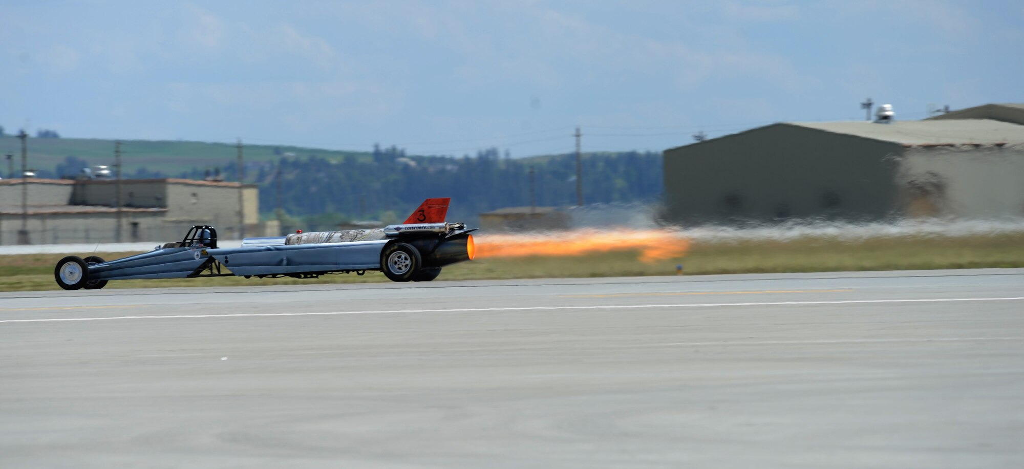 Bill Braack drives the Smoke-N-Thunder jet car during a performance during SkyFest 2014 at Fairchild Air Force Base, Wash., May 31, 2014. The jet car is equipped with a J34-48 engine originally used in the North American Buckeye T-2A aircraft. The jet car has 10,000 horsepower and 6,000 pounds of thrust with an afterburner. The jet car races at speeds approaching nearly 400 mph. During the performance, Braack pulls 4.5 Gs when accelerating and experiences 11 Gs of negative force as the car comes to a stop. (U.S. Air Force photo Airman 1st Class Janelle Patiño/Released)