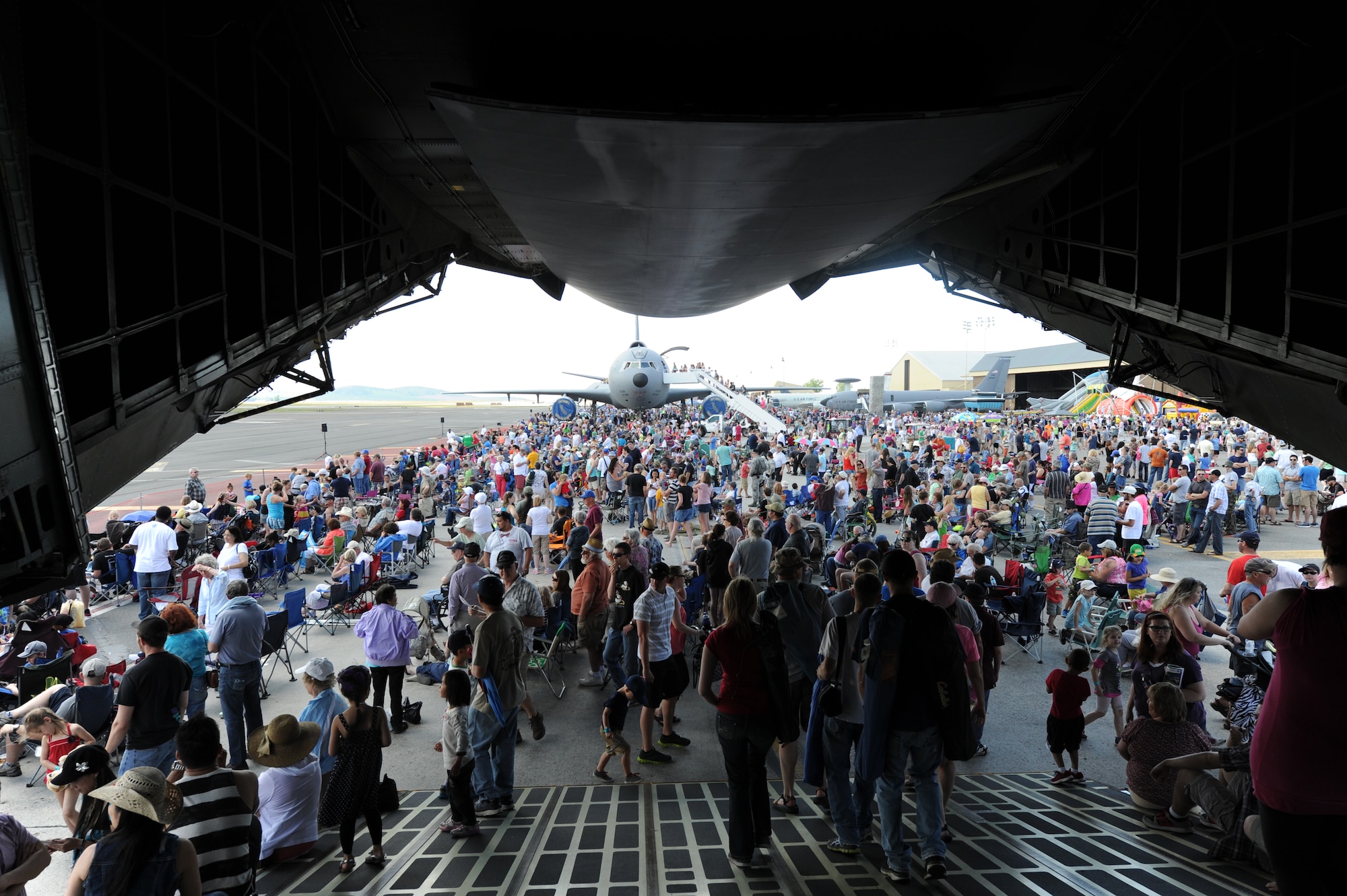 Service members and members from the local community walk off a C-5 Galaxy during SkyFest 2014 at Fairchild Air Force Base, Wash., May 31, 2014. SkyFest 2014 hosted more than 15 types of aircraft and static displays and more than 10 flying performers including the U.S. Air Force Thunderbirds and the U.S. Army Parachute Team, “Golden Knights.” (U.S. Air Force photo by Airman 1st Class Janelle Patiño/Released)