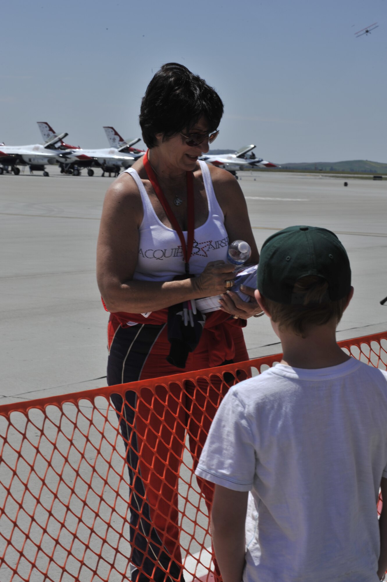 Jacquie Warda, "Jacquie B," signs autographs during SkyFest 2014 at Fairchild Air Force Base, Wash., June 1, 2014. Warda is the first female aerobatic pilot flying a Pitts Special biplane with more than nine years performing coast to coast and greater than 100 shows. (U.S. Air Force photo by Senior Airman Mary O'Dell/Released)
