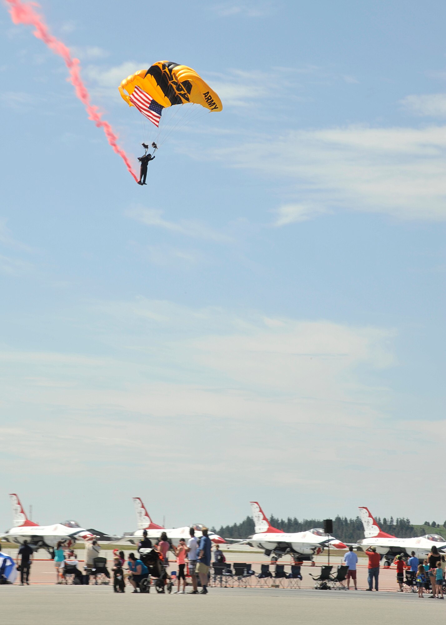 A member of the U.S. Army Parachute Team, "Golden Knights,"  decends towards the ground as the National Anthem is played during SkyFest 2014 at Fairchild Air Force Base, Wash., May 31, 2014. The Team’s mission today as part of the U.S. Army Marketing and Research Group is to support the U.S. Army’s recruiting and public relations efforts. (U.S. Air Force photo by Senior Airman Mary O'Dell/Released)