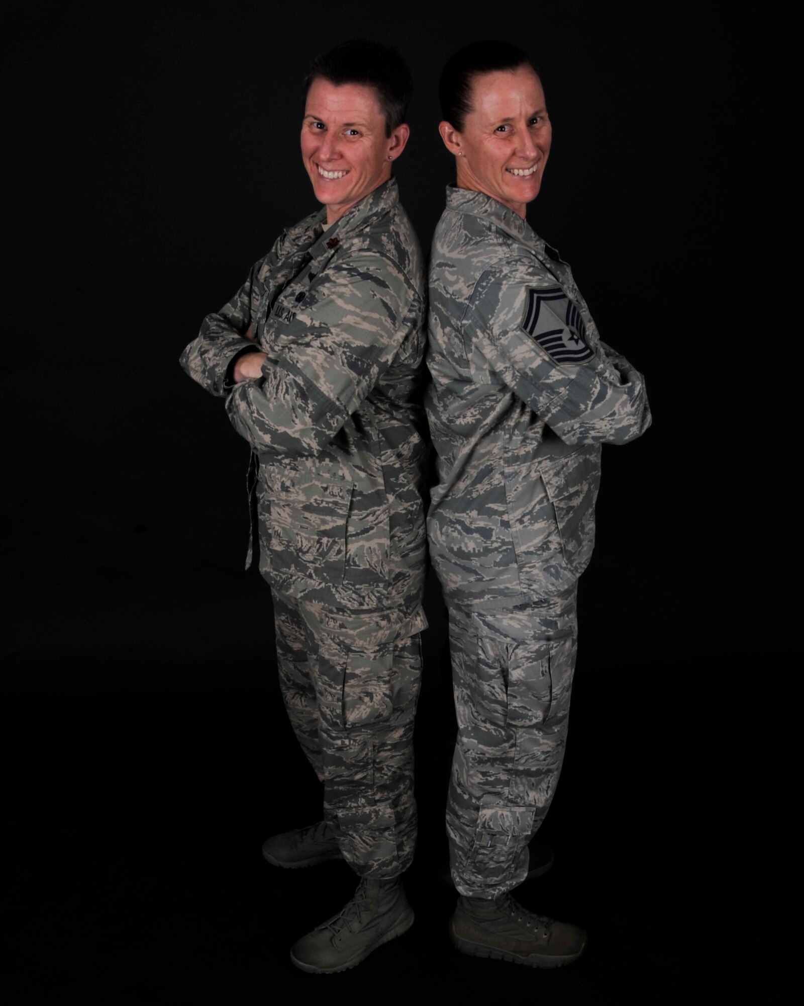 Maj. Caroline Beck, 1st Special Operations Air Operations Squadron senior duty officer, and Senior Master Sgt. Cathrine Beck, HQ Air Force Special Operations Command/A7 program manager, pose for a photo May, 29, 2014 at Hurlburt Field, Fla. The fraternal twins are serving here at Hurlburt together. (U.S. Air Force photo/Senior Airman Krystal M. Garrett) 
