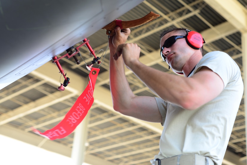 U.S. Air Force Staff Sgt. Justin Hubbard, 94th Fighter Squadron dedicated crew chief safes an F-22 Raptor at Langley Air Force Base, Va., June 4, 2014. Hubbard was hand-selected as the dedicated crew chief for his high level of readiness and efficiency in all maintenance areas. (U.S. Air Force photo by Staff Sgt. Antoinette Gibson/Released)