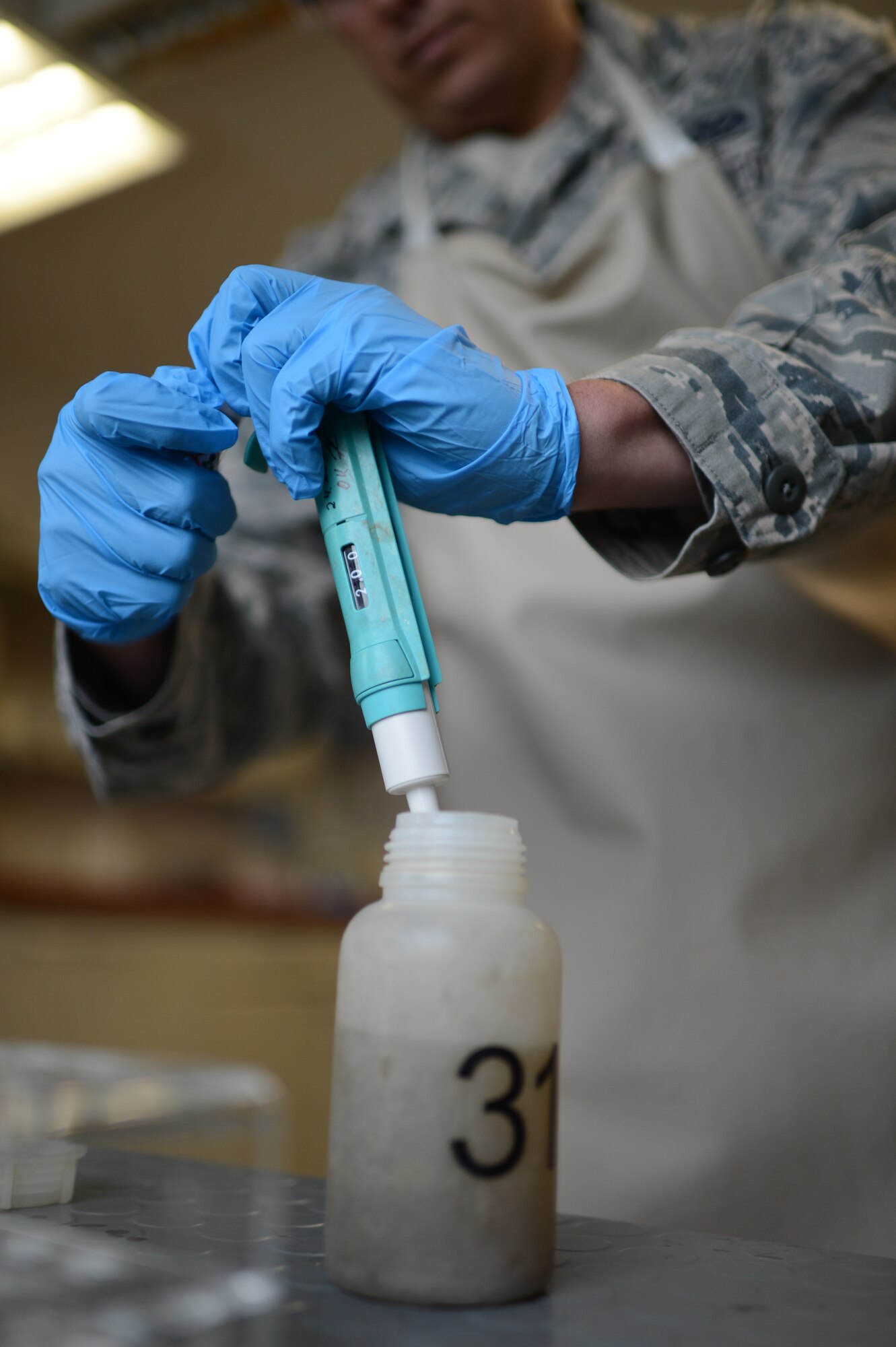 U.S. Air Force Airman 1st Class Joseph Dickerson, 52nd Civil Engineer Squadron water and fuel system maintenance technician from Oklahoma City, Okla., extracts a portion of a wastewater sample at Spangdahlem Air Base, Germany, June 4, 2014. Airmen add a chemical oxygen demand reagent to the extracted sample to cause a chemical reaction that can be analyzed by testing equipment to ensure the proper levels are followed under German law. (U.S. Air Force photo by Senior Airman Gustavo Castillo/Released)