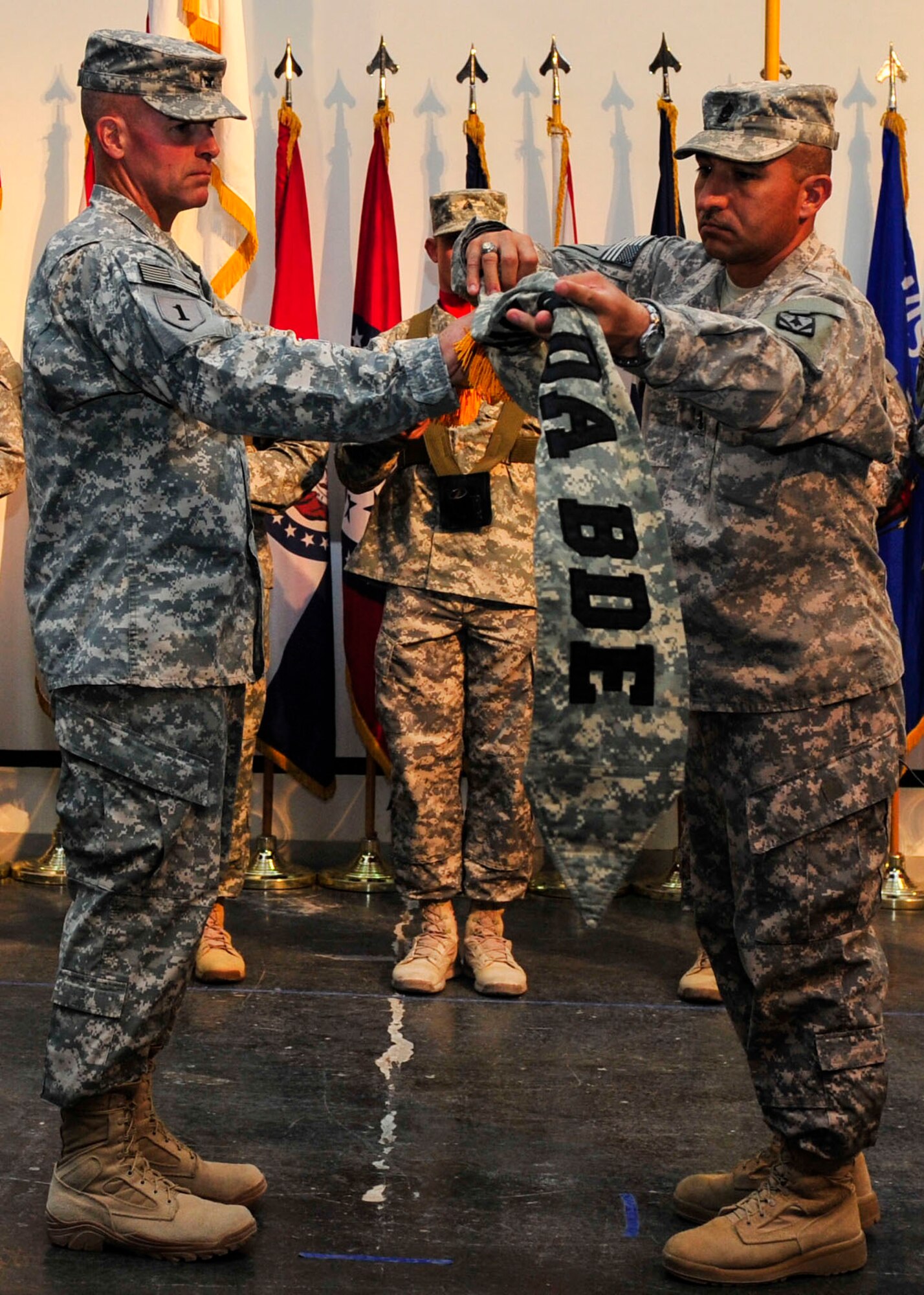 U.S. Army Col. Michael Morrissey, 31st Air Defense Artillery Brigade commander and Command Sgt. Major Gerardo Dominguez, 31st Air Defense Artillery Brigade sergeant major, case their brigade colors during a transfer of authority ceremony at Al Udeid Air Base, Qatar, May 30, 2014. The 31st ADA completed a nine month deployment in support of Operation Enduring Freedom. The 31st ADAB is deployed from Fort Sill, Oklahoma. (U.S. Air Force photo by Senior Airman Colin Cates)