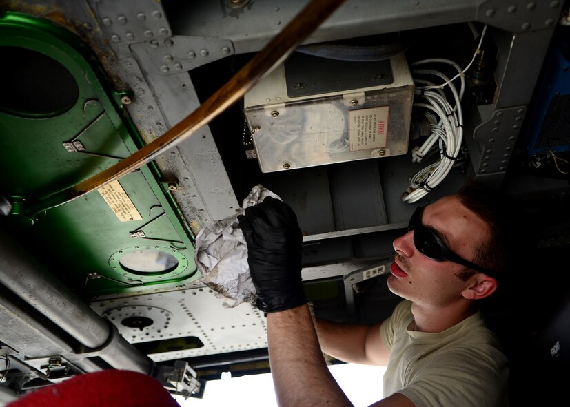 U.S. Air Force Airman 1st Class Cody White, 455th Expeditionary Aircraft Maintenance Squadron, cleans the inside of an HH-60G Pave Hawk helicopter at Bagram Airfield, Afghanistan June 2, 2014.  The unit is preparing their helicopters for redeployment to their home base Moody Air Force Base, Ga.  Maintainers here work a non-stop alert schedule to maintain high mission-capable ratings and are ready to respond 24 hours a day, seven days a week.   White is deployed from the 41st Rescue Squadron and a native of Henderson, Ky.(U.S. Air Force photo by Staff Sgt. Evelyn Chavez/Released)