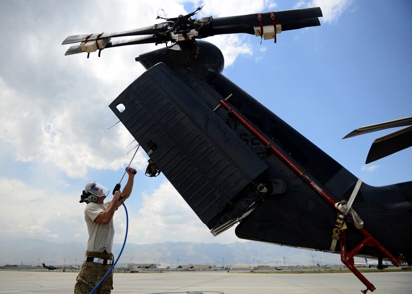 U. S. Air Force Senior Airman Lucas Stone, 455th Expeditionary Aircraft Maintenance Squadron crew chief, washes an HH-60G Pave Hawk at Bagram Airfield, Afghanistan June 2, 2014. The Pave Hawk must be cleaned thoroughly and then folded up in order to be shipped back to his home base Moody Air Force Base, Ga. Lucas is deployed from the 41st Rescue Squadron and a native of Hershey, Pa. (U.S. Air Force photo by Staff Sgt. Evelyn Chavez/Released)