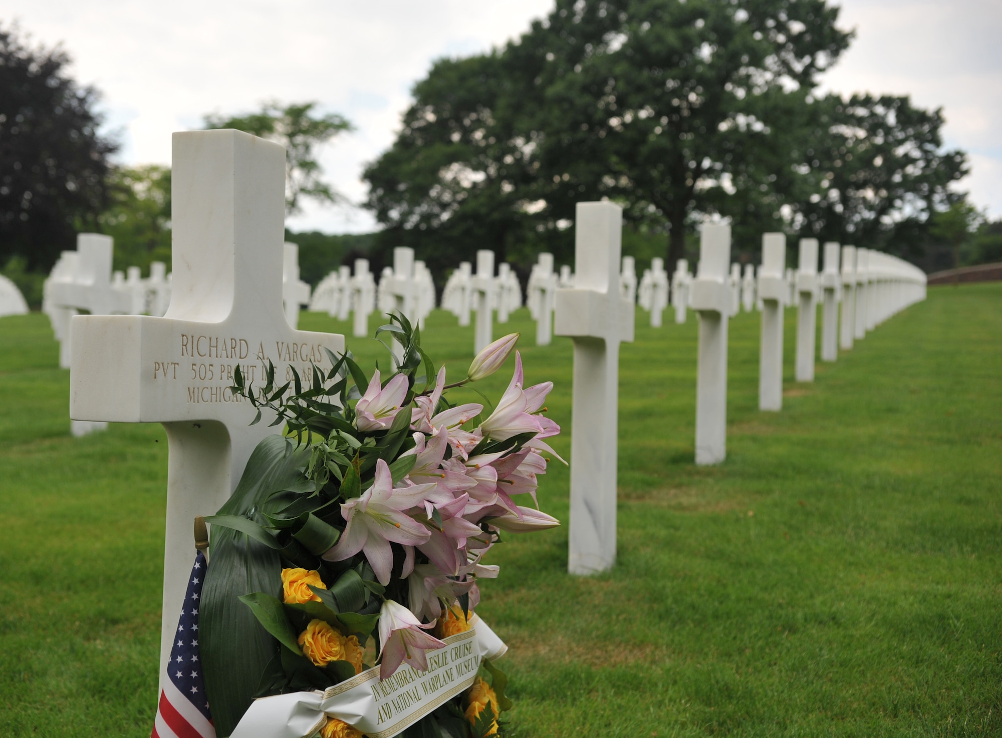 A wreath lays in front of Pvt. Richard Vargas’ grave after a ceremony that took place at Lorraine American National Cemetery and Memorial, St. Avold, France, June 2, 2014. Seventy years ago on June 7, 1944 Pvt. Richard Vargas saved Leslie Cruise’s life, a World War II veteran, during the invasion of Normandy. Cruise went to France several times prior to this visit looking for his friend’s grave in order to say thank you. (U.S. Air Force photo/Senior Airman Hailey Haux)