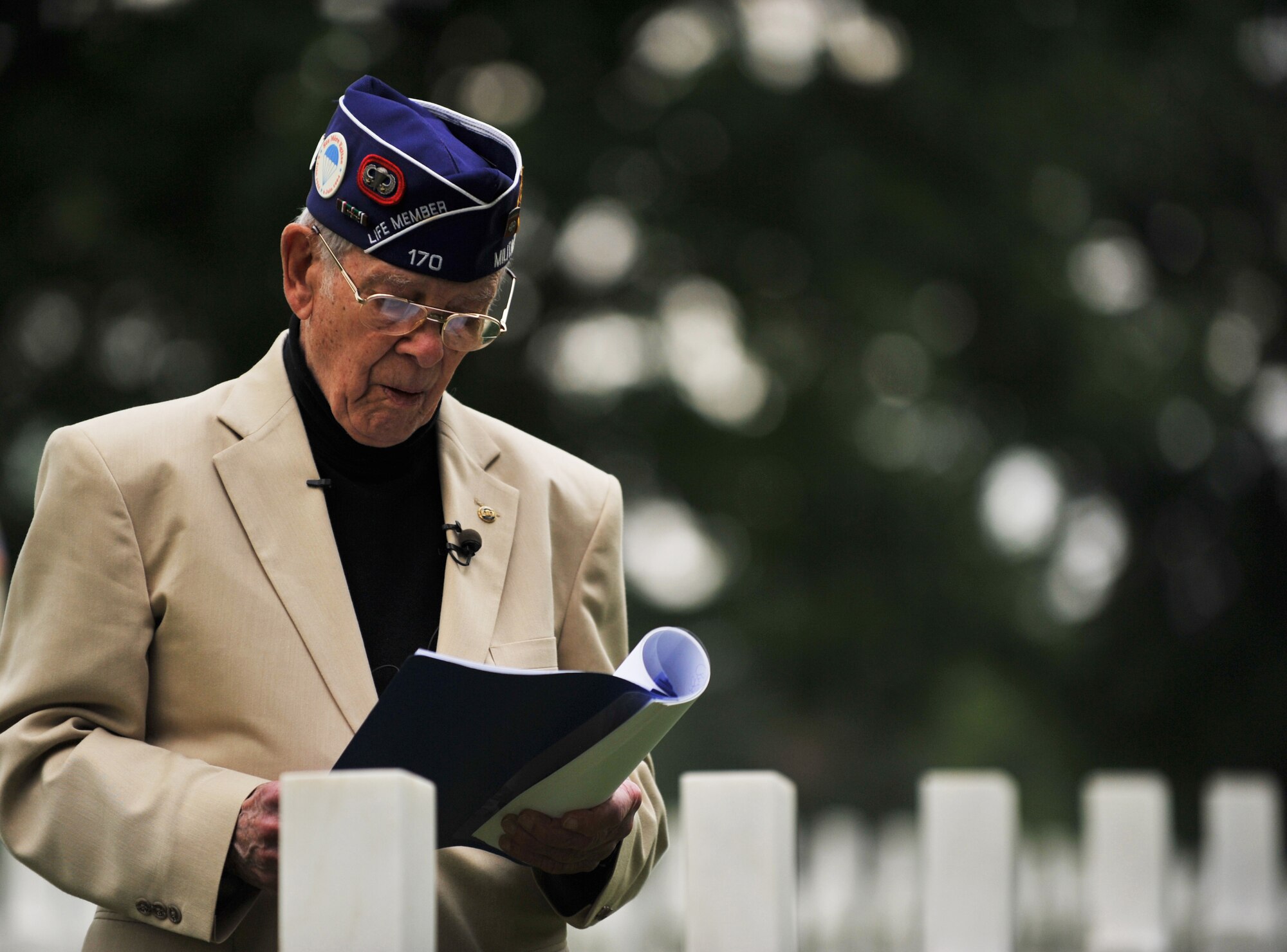 Leslie Cruise, a World War II veteran, reads the paratroopers creed during a wreath laying ceremony at Lorraine American National Cemetery and Memorial, St. Avold, France, June 2, 2014. Seventy years ago on June 7, 1944 Pvt. Richard Vargas saved Cruise’s life during the invasion of Normandy. Cruise went to France several times prior to this visit looking for his friend’s grave in order to say thank you. (U.S. Air Force photo/Senior Airman Hailey Haux)