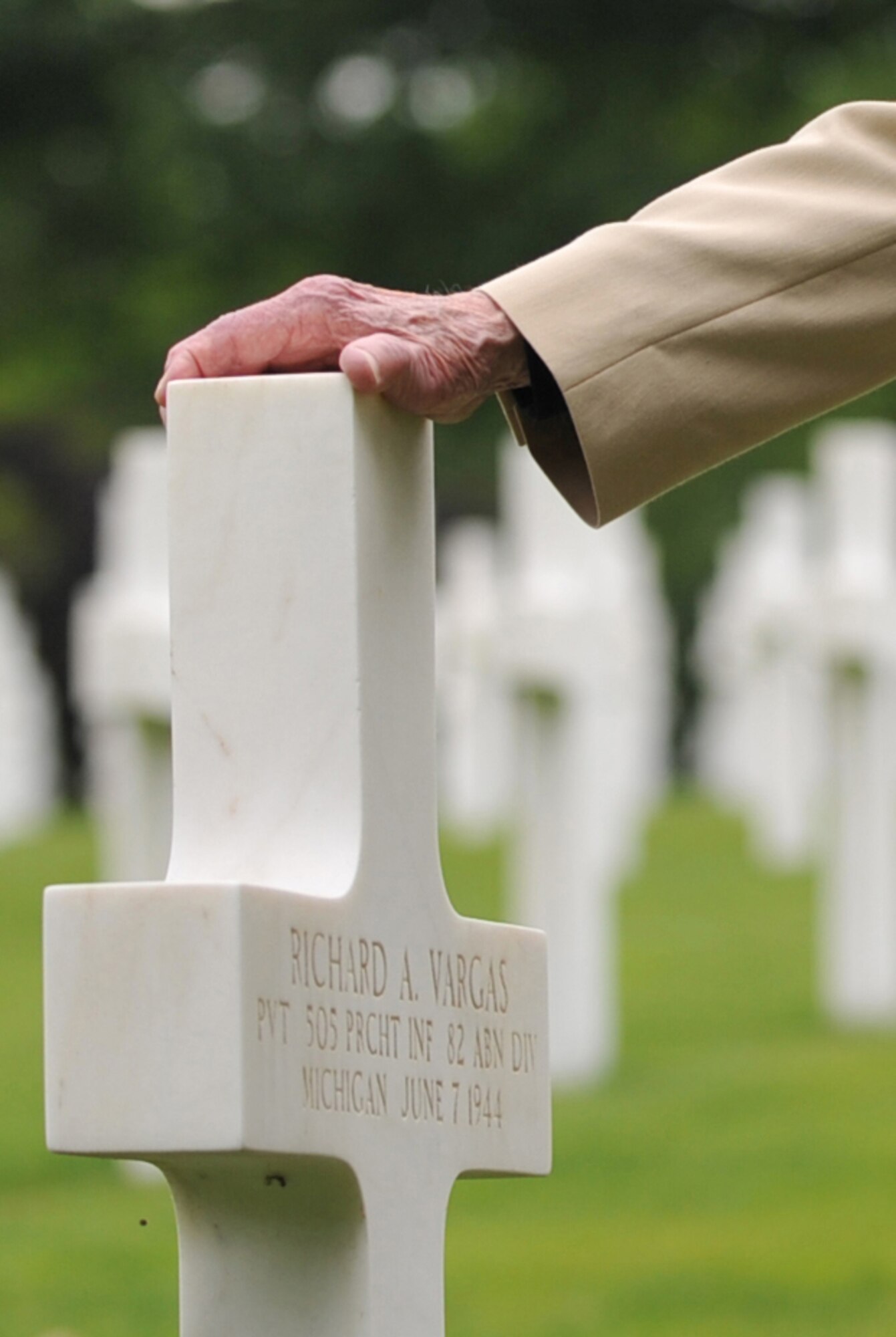 Leslie Cruise, a World War II veteran, pays his respects to the man who saved his life seventy years ago with a wreath laying ceremony at Lorraine American National Cemetery and Memorial, St. Avold, France, June 2, 2014. Seventy years ago on June 7, 1944 Pvt. Richard Vargas saved Cruise’s life during the invasion of Normandy. Cruise went to France several times prior to this visit looking for his friend’s grave in order to say thank you. (U.S. Air Force photo/Senior Airman Hailey Haux)
