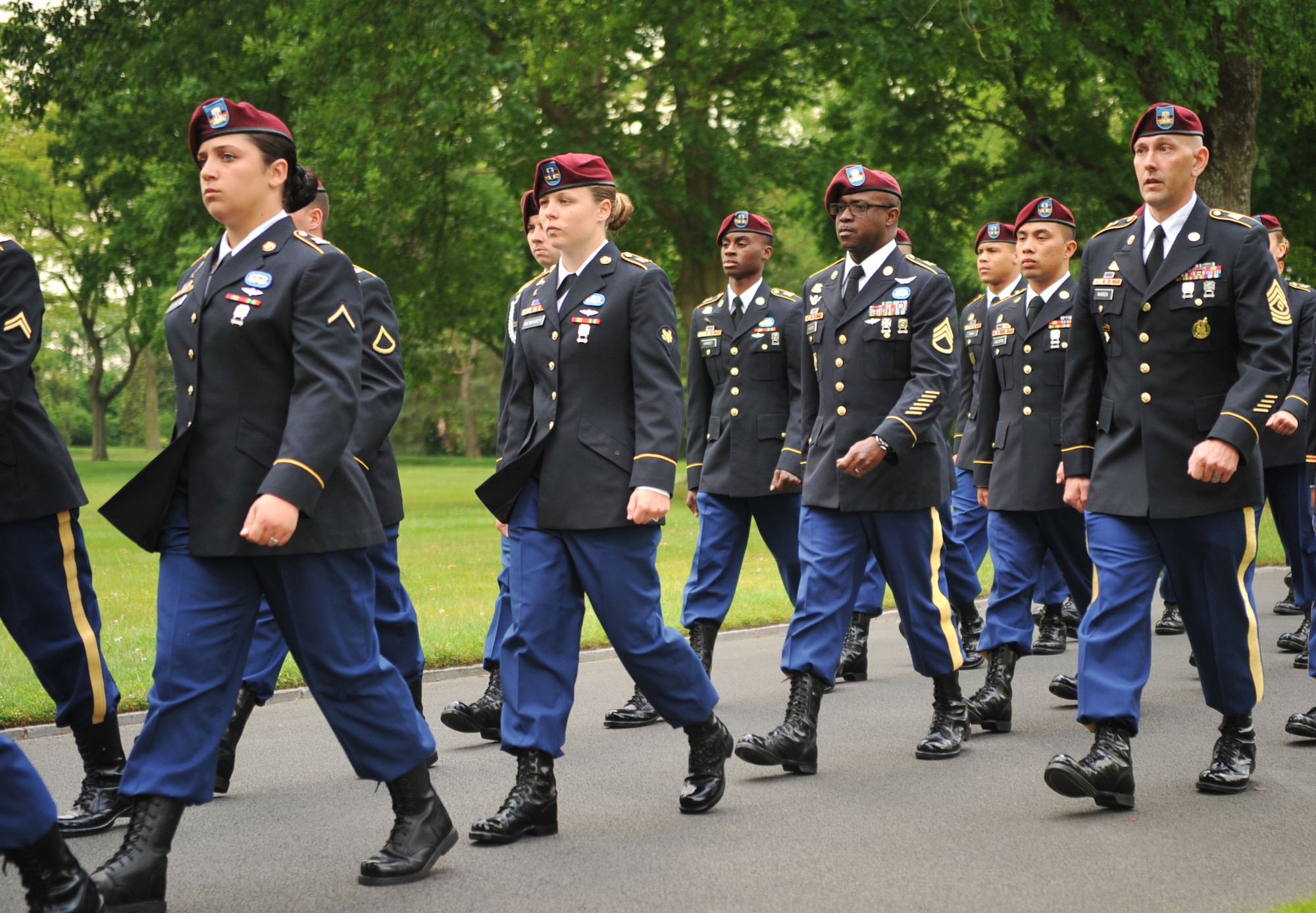 Members from the 5th Quartermaster Theater Aerial Delivery Company, 435th Air Ground Operations Wing’s Contingency Response Group and 21st Theater Sustainment Command march toward the grave of Pvt. Richard Vargas during a wreath laying ceremony at Lorraine American National Cemetery and Memorial, St. Avold, France, June 2, 2014. Vargas saved the life of Leslie Cruise, a World War II veteran. Cruise went to France several times prior to this visit looking for his friend’s grave in order to say thank you. (U.S. Air Force photo/Senior Airman Hailey Haux)
