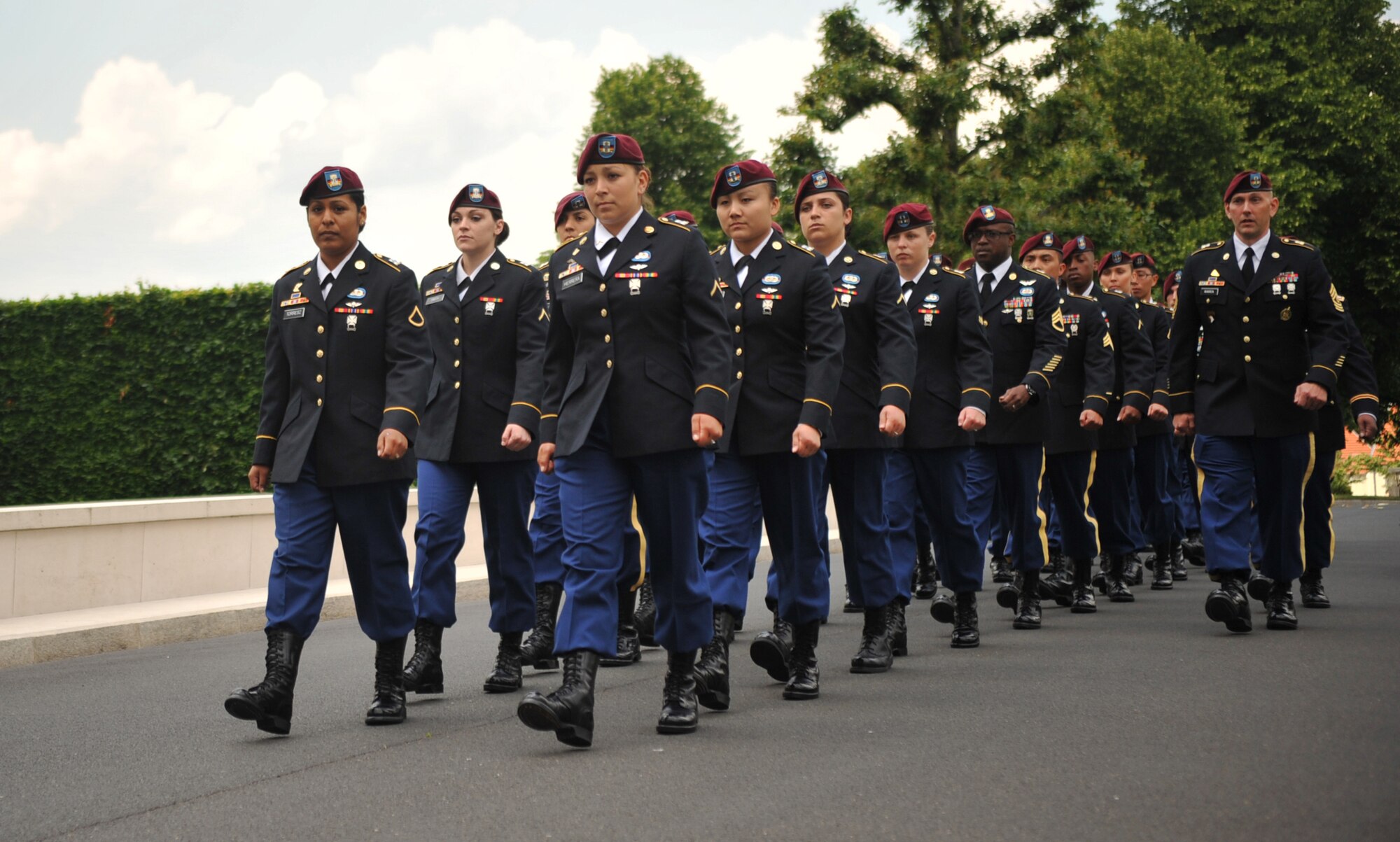Members from the 5th Quartermaster Theater Aerial Delivery Company, 435th Air Ground Operations Wing’s Contingency Response Group and 21st Theater Sustainment Command march toward the grave of Pvt. Richard Vargas during a wreath laying ceremony at Lorraine American National Cemetery and Memorial, St. Avold, France, June 2, 2014. Vargas saved the life of Leslie Cruise, a World War II veteran. Cruise went to France several times prior to this visit looking for his friend’s grave in order to say thank you. (U.S. Air Force photo/Senior Airman Hailey Haux)