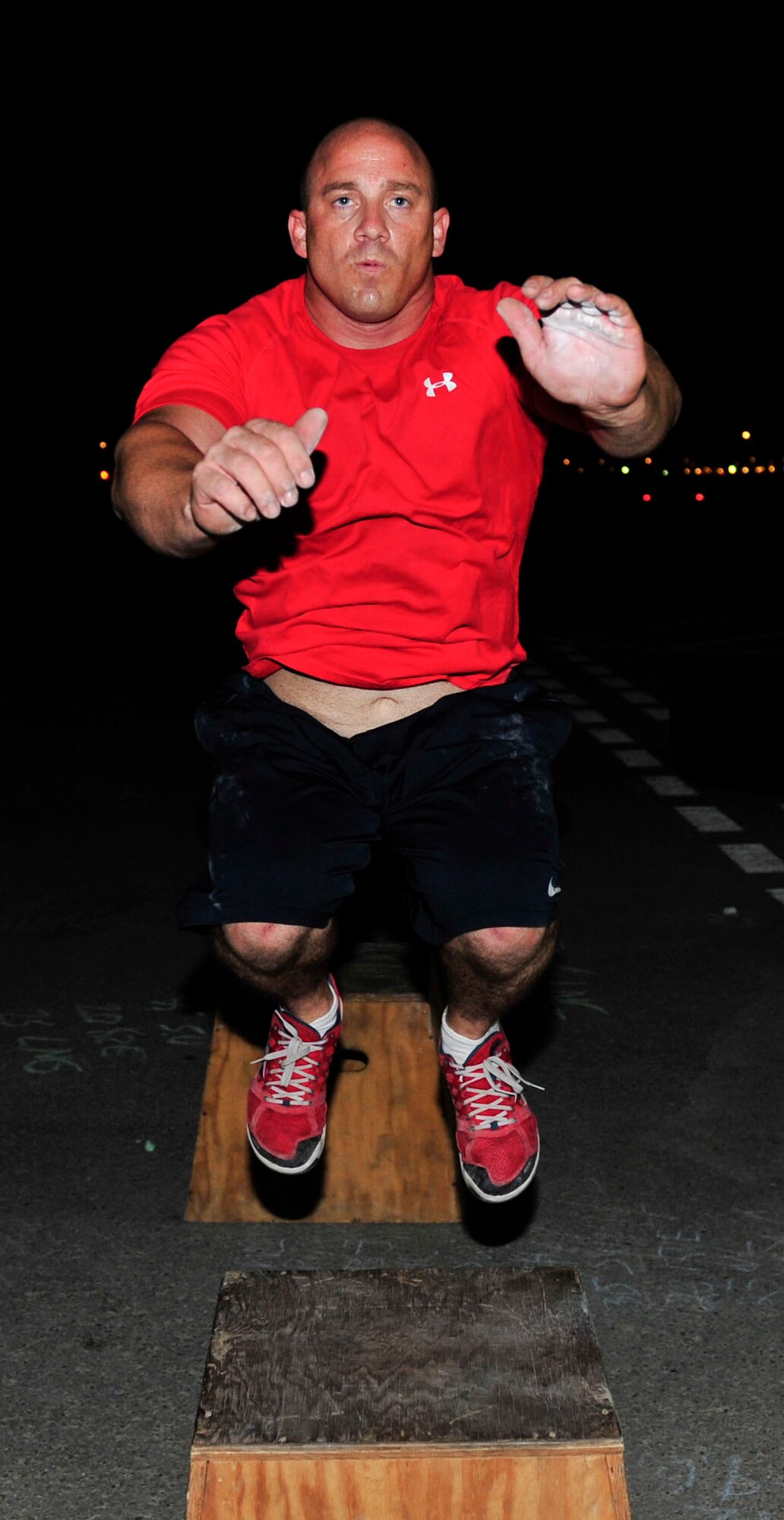 U.S. Air Force Tech. Sgt. Erin Louden, 379th Expeditionary Logistics Readiness Squadron fuel operations superintendent, performs a box jump during a CrossFit workout at Al Udeid Air Base, Qatar, May 21, 2014. This movement trains the explosive component of fitness while providing power and coordination from jumping. Louden’s home station is Dover Air Force Base, Delaware, and his hometown is Fresno, California.(U.S. Air Force photo by Senior Airman Colin Cates)