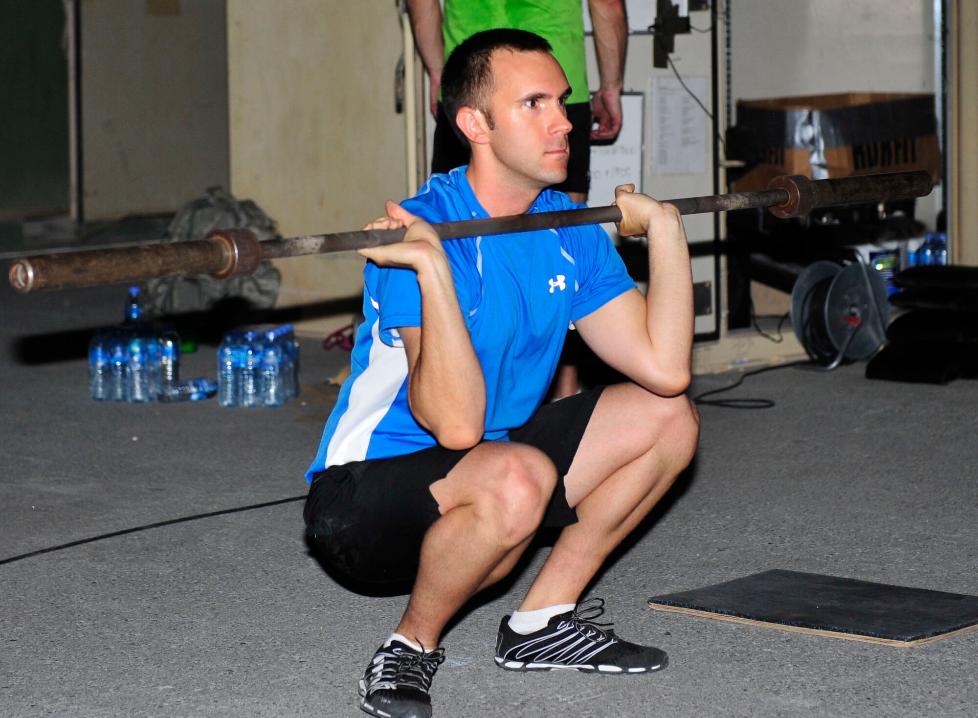 U.S. Air Force Capt., Zachary Walker, U.S. Central Command Forward Headquaters intelligence team officer in charge, performs a front squat during a CrossFit workout session at Al Udeid Air Base, Qatar, May 21, 2014. CrossFit's fitness approach is to improve an athlete's capacity to excel within 10 general physical skills – cardiovascular endurance, stamina, strength, flexibility, power, speed, coordination, agility, balance and accuracy. Walker’s home station is Fort Meade, Maryland, and his hometown is Paris, Texas. (U.S. Air Force photo by Senior Airman Colin Cates)