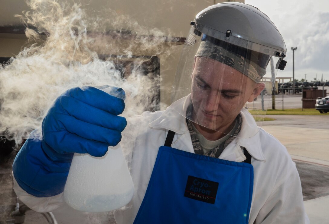 Airman 1st Class Nathanael Markley, 36th Logistics Readiness Squadron cryogenics lab technician, holds a beaker with liquid oxygen on Andersen Air Force Base, Guam. The 36th LRS cryogenics production technician team is one of two base-level cryogenics teams left in the Air Force that still makes all of its own products. (U.S. Air Force photo by Airman 1st Class Adarius Petty)