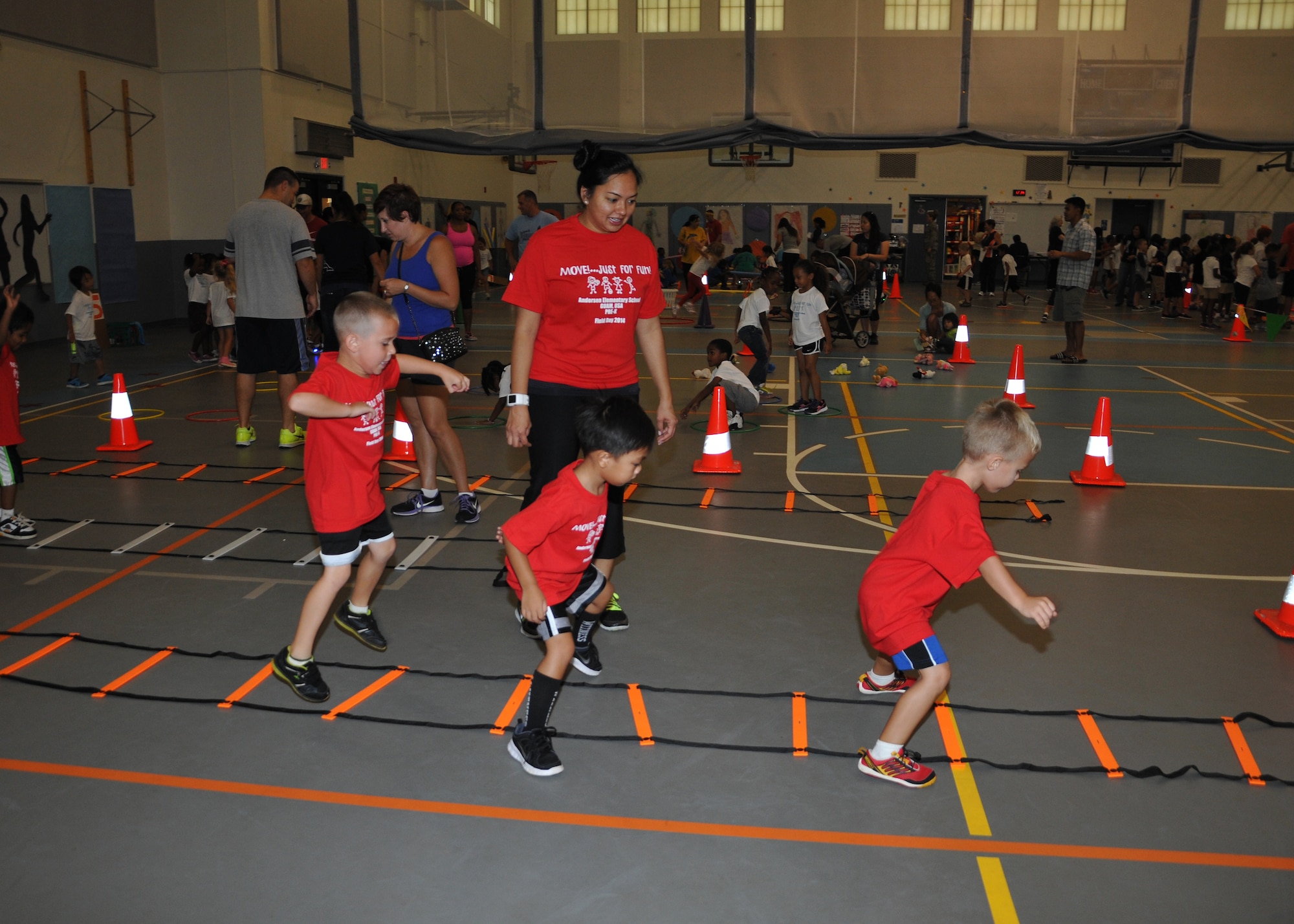 Children from Andersen Elementary School participate in a game of ladders May 30, 2014, on Andersen Air Force Base, Guam.
Andersen volunteers led each group of children through the various games. (U.S. Air Force photo by Senior Airman Cierra Presentado/Released)
