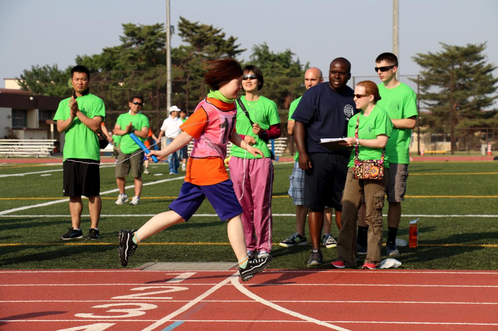 An athlete crosses the finish line during the 400 meter relay at the Special Olympics at Yokota Air Base, Japan, May 31, 2014. Olympians participated in various track and field events throughout the day. (Courtesy photo Staff Sgt. Jeffrey MacHott/Released)