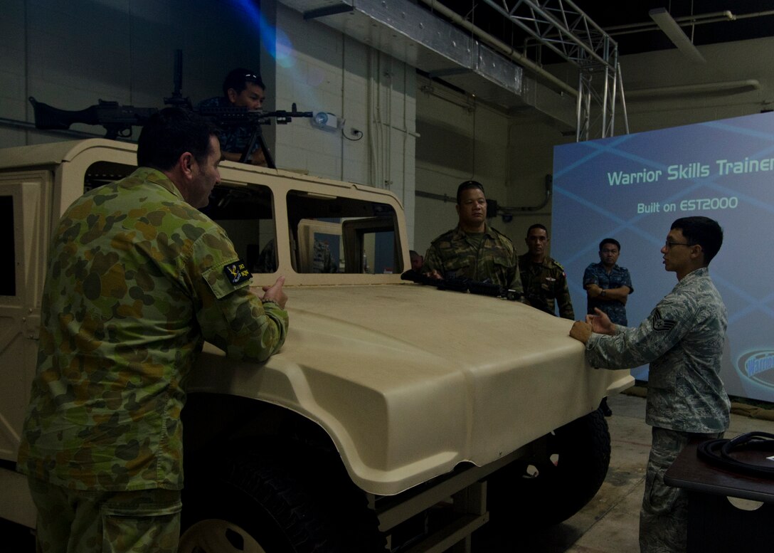 Participants in the Pacific Defender subject matter expert exchange participate in the warrior skills combat trainer May 28, 2014, on Andersen Air Force Base, Guam. Andersen hosted the Pacific Defender security forces international subject-matter expert exchange May 19-23 in an effort to continue to build partnerships and promote interoperability.
The official party included members from the Mongolian, Tongan, Thai, U.S., and Australian air forces. (U.S. Air Force photo by Senior Airman Katrina Brisbin/Released)
