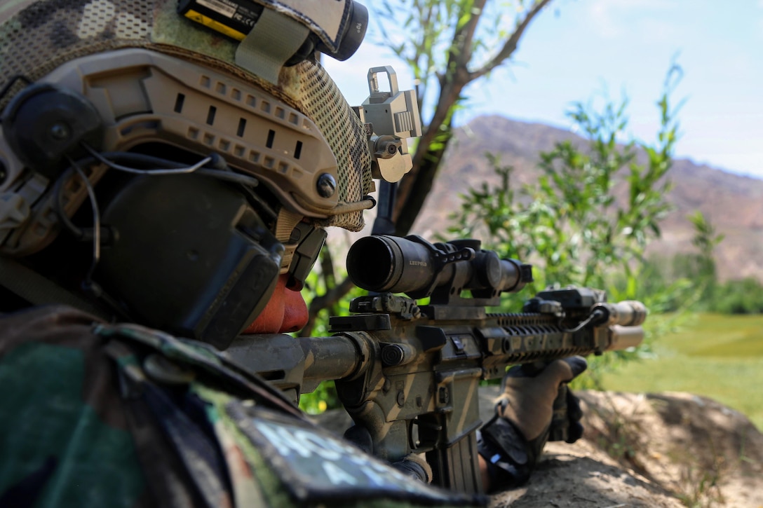 A U.S. Special Forces soldier scans an open field for activity after ...