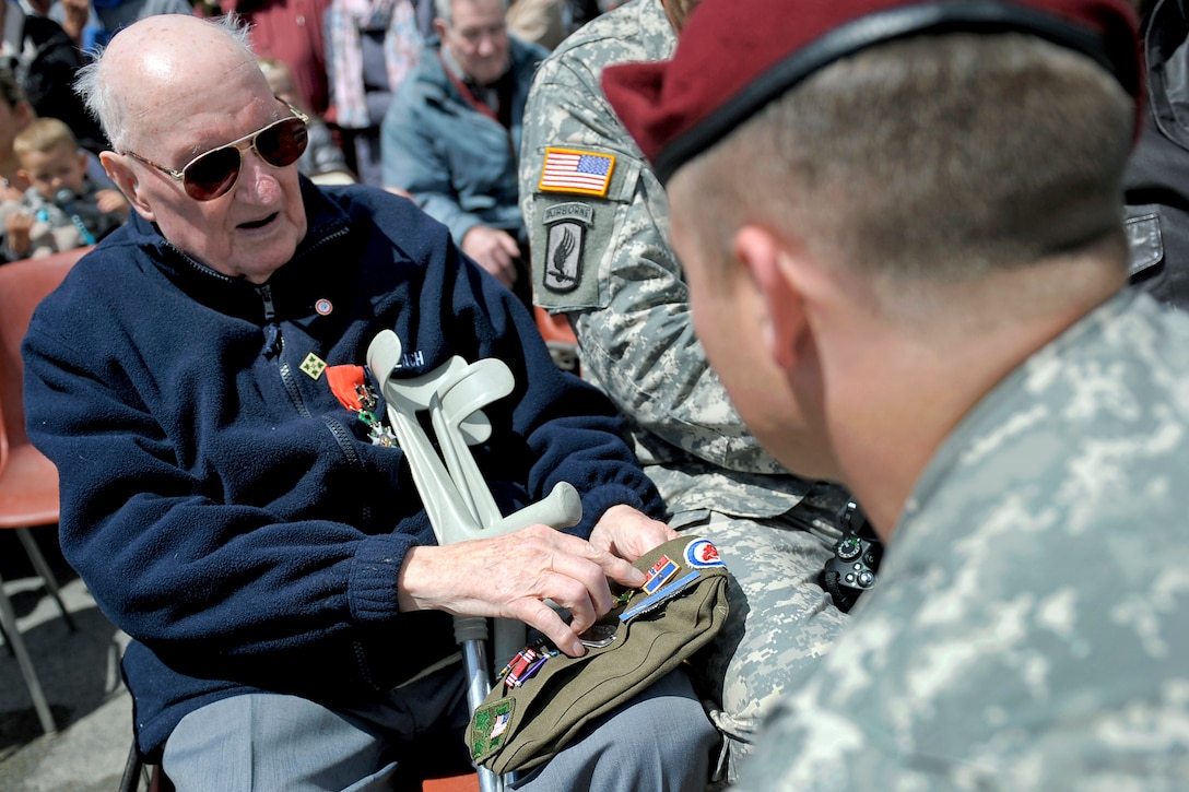 Curtis Phillips, left, a U.S. Army veteran who landed on Utah Beach in ...