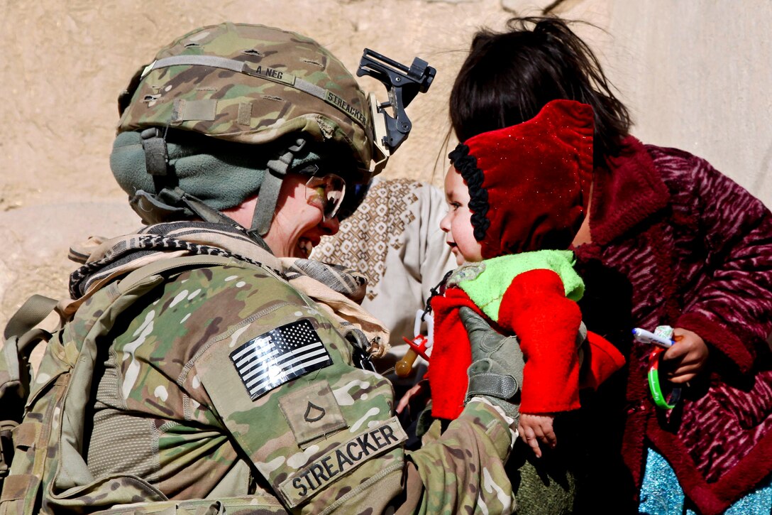U.S. Army Pfc. Sierra Streacker interacts with children in Afghanistan's Ghazni province, Dec. 31, 2011. Streacker is assigned to the 25th Infantry Division's Company F, 2nd Battalion, 5th Infantry Regiment.  
