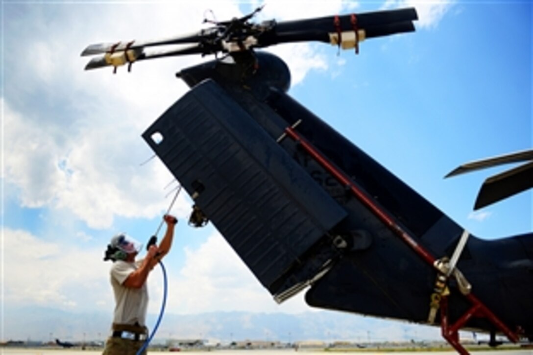 U. S. Air Force Senior Airman Lucas Stone washes an HH-60G Pave Hawk on Bagram Airfield, Afghanistan, June 2, 2014. The Pave Hawk is being prepared for shipment home to Moody Air Force Base, Ga. Lucas is a squadron crew chief with the 41st Rescue Squadron, assigned to the 455th Expeditionary Aircraft Maintenance.