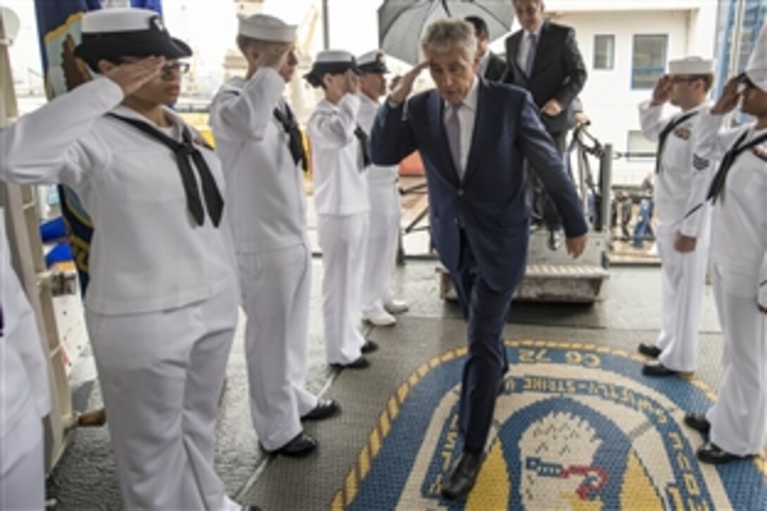 U.S. Defense Secretary Chuck Hagel salutes as he boards the USS Vella Gulf in Constanta, Romania, June 5, 2014. The Vella Gulf is deployed to the U.S. 6th Fleet area of responsibility to contribute to regional maritime security and to support NATO operations and deployments throughout the region.