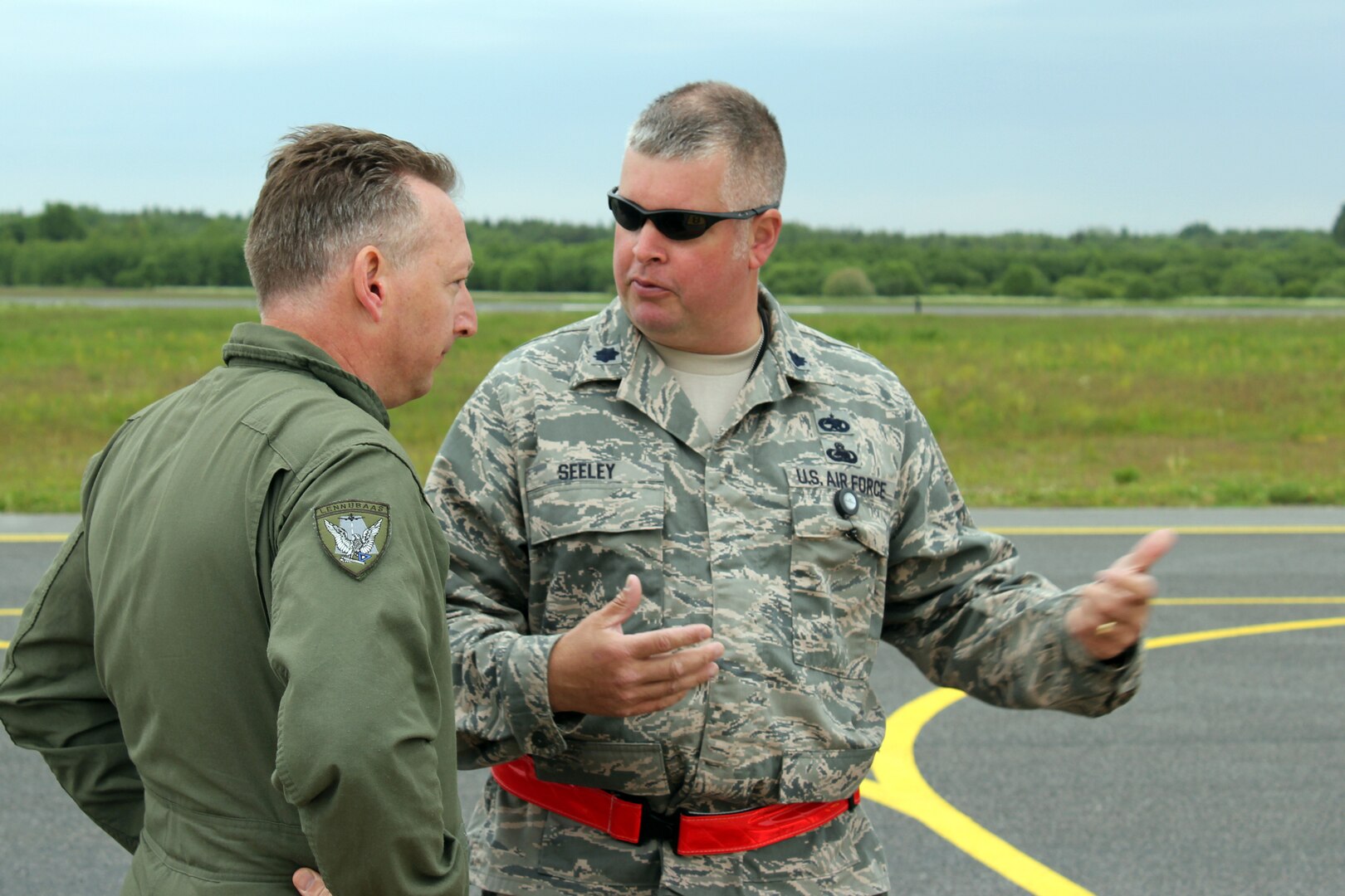 Estonian air force Lt. Col. Roman Timofejev, left, talks with Lt. Col. Robert Seeley on the flight line at the Amari Air Base in Estonia, June 10, 2012. Michigan Air National Guard airmen deployed to Estonia in mid-June 2012 in support of Saber Strike 2012, a multinational exercise based in Latvia and Estonia.