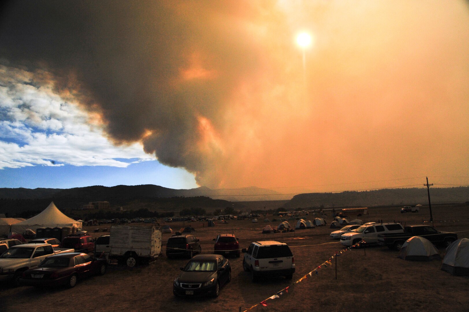 Smoke from the High Park fire rises is the distance at the Incident Command Post at the Colorado National Guard Readiness Center near Fort Collins, Colo.