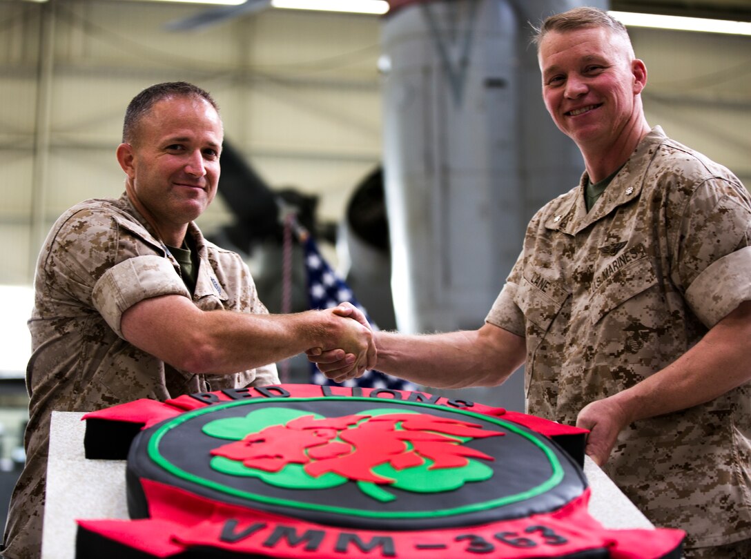 Master Sgt. Joseph Cutolo, maintenance control chief with Marine Medium Tiltrotor Squadron (VMM) 363, left, poses with Lt. Col. David L. Lane, commanding officer of VMM-363 next to a cake made to resemble the new squadron insignia aboard Marine Corps Air Station Miramar, Calif., June 2. The cake was part of the squadron’s 62nd anniversary, which commemorated the squadron’s history, new insignia and fully operational capabilities.