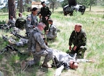 Soldiers from the 860th Military Police Company and the Danish Home Guard Force Protection Platoon conduct first-aid training on West Camp Rapid during the Golden Coyote training exercise, June 11, 2012, in Rapid City, S.D. National Guard, reserve and international forces use the exercise as an opportunity to conduct joint training in support of overseas contingency operations and homeland defense.