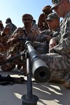 Army Staff Sgt. Jon Paul Steenbakkers, an Arabic linguist with the 341st Military Intelligence Battalion, part of the 300th Military Intelligence Brigade, translates instructions on operating a .50-caliber machine gun to a soldier from the Royal Army of Oman's 11th Brigade, Western Frontier Regiment, at the Rubkut Training Range in Oman, Jan. 21, 2012. The linguists were in Oman with the Oregon National Guard's 1st Squadron, 82nd Cavalry Regiment and a platoon from the 125th Forward Support Company, 1st Battalion, 194th Field Artillery Regiment from Joint Base Lewis McCord, Wash., as part of a two week training exercise with Omani soldiers as a way to share knowledge and build greater diplomatic relations.