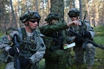 Soldiers with the Pennsylvania Army National Guard work with a Lithuanian soldier, center, during an exercise in Saber Strike 2013 in Adazi, Latvia, June 4, 2013. S