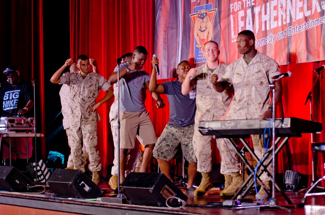 MARINE CORPS BASE HAWAII - Audience members dance onstage during the For the Leathernecks III Comedy and Entertainment Tour at the base theater, June 4, 2014. The tour featured Ben Gleib, Ronnie Jordan and Mark Viera, THE FARM, and DJ Big Mike. (U.S. Marine Corps photo by Kristen Wong)