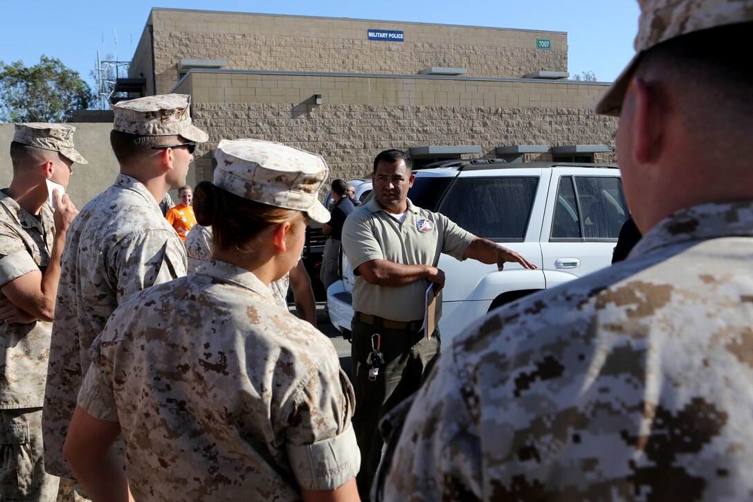 Jose Maldonado, lead instructor with Homeland Security Solutions, Inc., instructs Marines on the proper procedure to perform a standard field sobriety test aboard Marine Corps Air Station Miramar, Calif., June 4.  The annual training was held with the help of intoxicated volunteers from various commands around the air station.