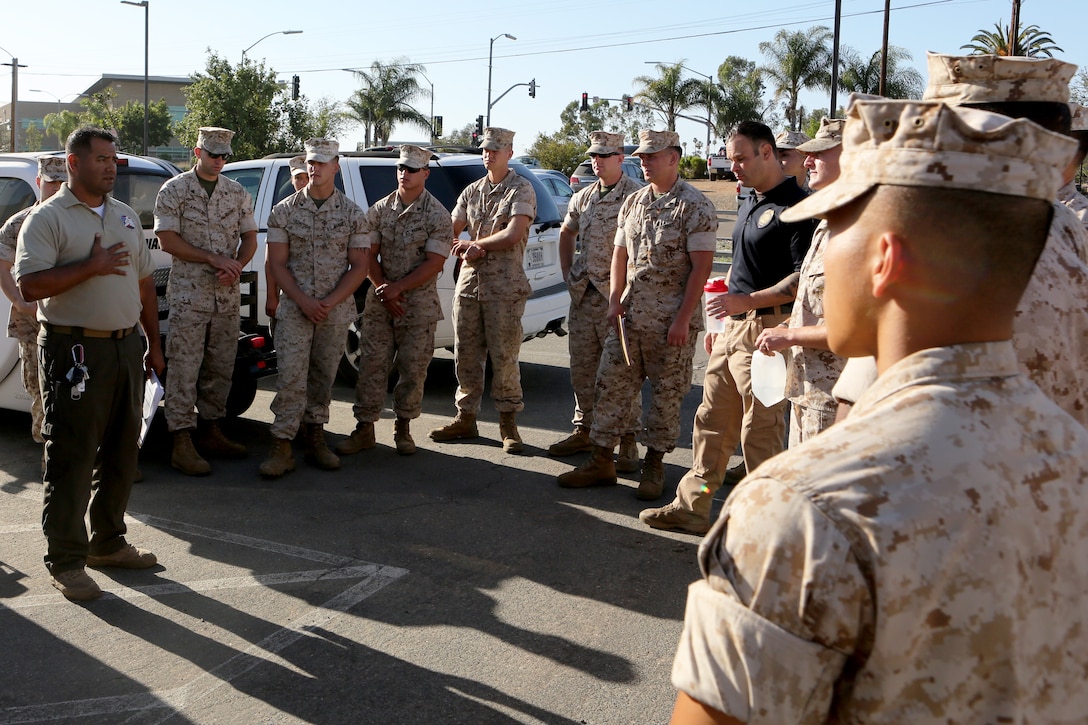 Jose Maldonado, lead instructor with Homeland Security Solutions, Inc., instructs Marines on the proper procedures expected of them during a field sobriety test aboard Marine Corps Air Station Miramar, Calif., June 4. The annual training was held with the help of intoxicated volunteers to better simulate the effects of alcohol.