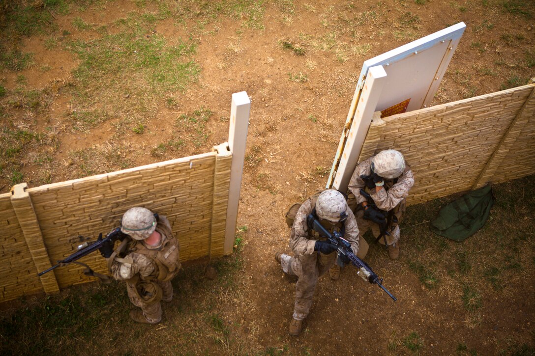 U.S. Marines assigned to India Company, 3D Battalion, 3D Marine Regiment, enter a compound gate during a search and rescue mission at the Boondocker Training Area aboard Marine Corps Base (MCB) Hawaii, May 29th, 2014. The Marines from 3/3 conducted Amphibious, Offensive, and Stability Operations which developed small unit level leadership and increased their lethality and ability to fight whenever the battalion is called upon. (U.S Marine Corps photo by Lance Cpl. Aaron S. Patterson, MCBH Combat Camera/Released)