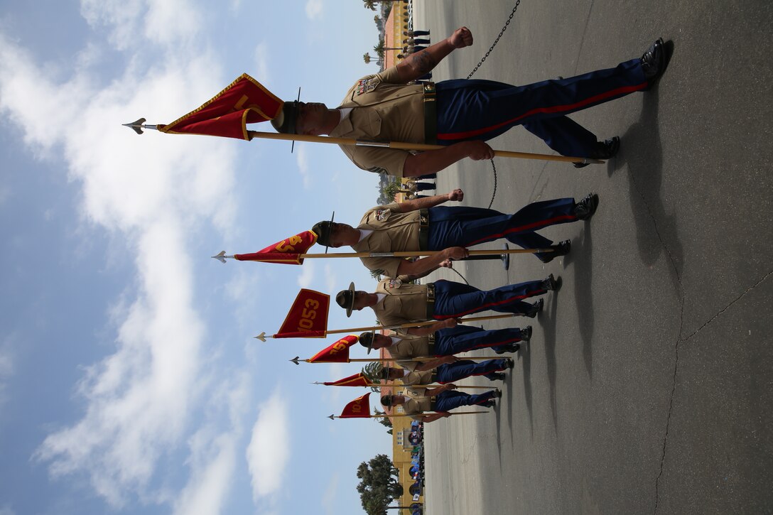 Drill Instructors of Charlie Company, 1st Recruit Training Battalion, carry their guidons off the parade deck during graduation aboard Marine Corps Recruit Depot San Diego, June 6. (Photo by Tyler Viglione)