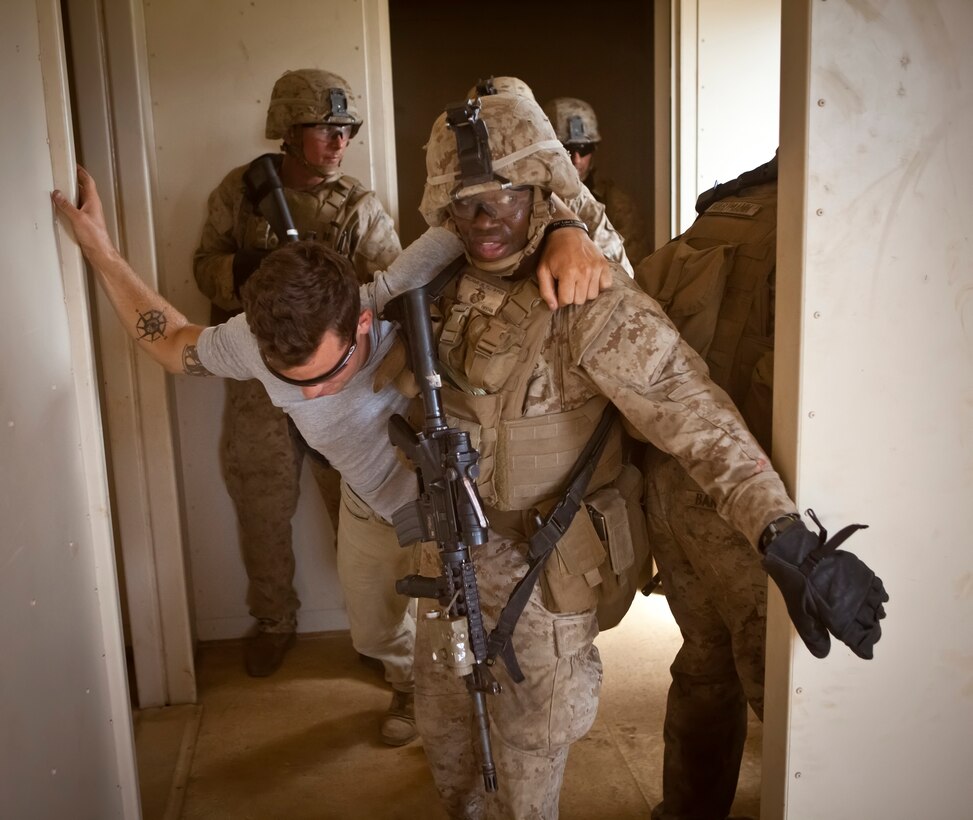 U.S. Marine Corps Lance Cpl. Tylon L. Williams Jr., a squad leader assigned to India Company, 3rd Battalion, 3rd Marine Regiment, rescues a simulated hostage during a search and rescue mission at the Boondocker Training Area aboard Marine Corps Base Hawaii, May 29, 2014. The Marines from 3rd Bn., 3rd Marines conducted Amphibious, Offensive, and Stability Operations which developed small unit level leadership and increased their lethality and ability to fight whenever the battalion is called upon. (U.S Marine Corps photo by Lance Cpl. Aaron S. Patterson, MCBH Combat Camera/Released)