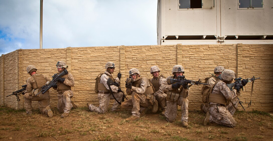 U.S. Marines assigned to India Company, 3rd Battalion, 3rd Marine Regiment, provide security outside of a compound wall during a search and rescue mission at the Boondocker Training Area aboard Marine Corps Base Hawaii, May 29, 2014. The Marines from 3rd Bn., 3rd Marines conducted Amphibious, Offensive, and Stability Operations which developed small unit level leadership and increased their lethality and ability to fight whenever the battalion is called upon. (U.S Marine Corps photo by Lance Cpl. Aaron S. Patterson, MCBH Combat Camera/Released)