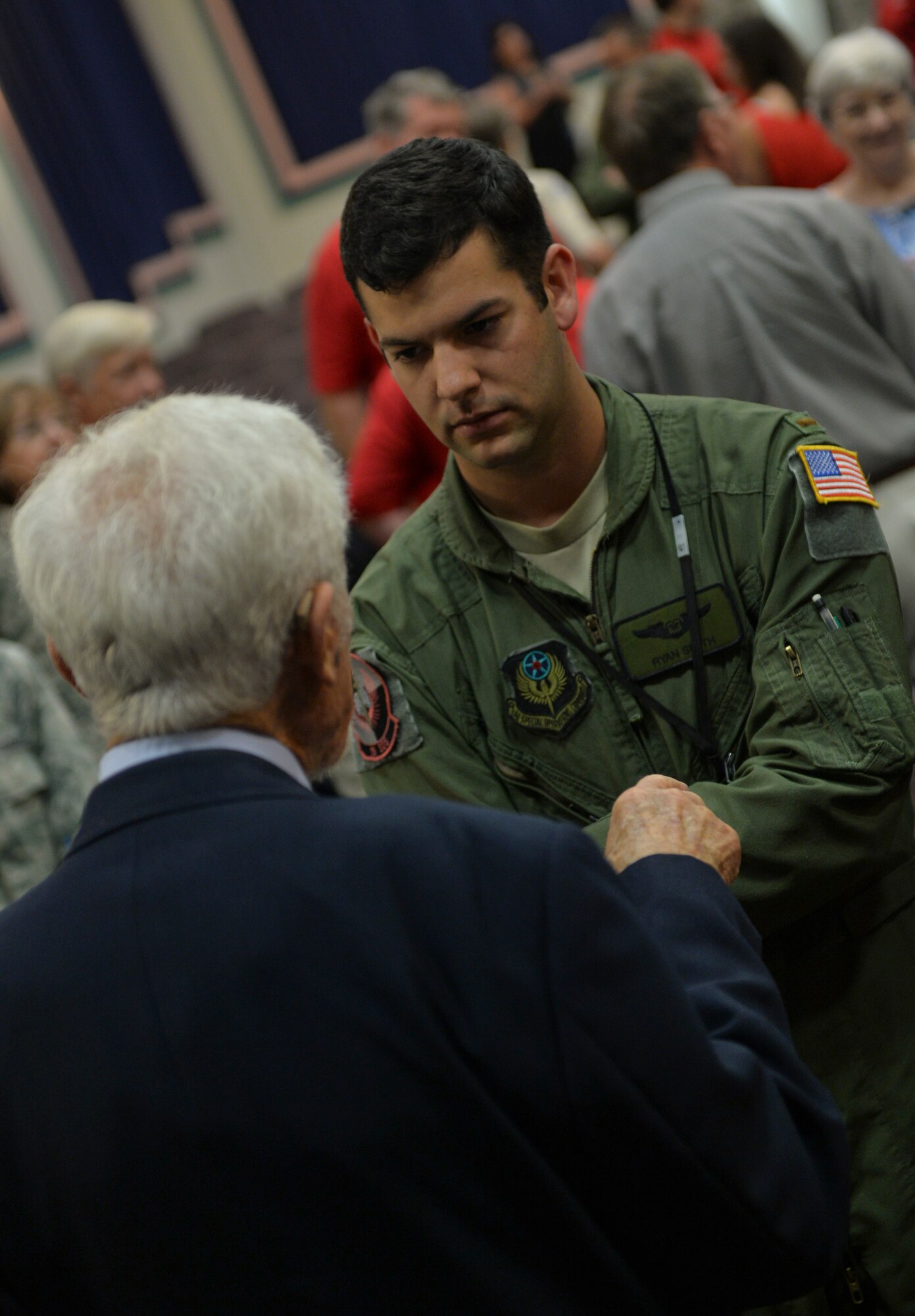 Retired Lt. Gen. LeRoy Manor meets with an attendee during an commerative seminar on Hurlburt Field, Fla., June 6, 2014. Manor flew his P-47 over Normandy Beach and provided escort for C-47s responsible for towing gliders and air dropping paratroopers. (U.S. Air Force photo/Senior Airman Christopher Callaway) 