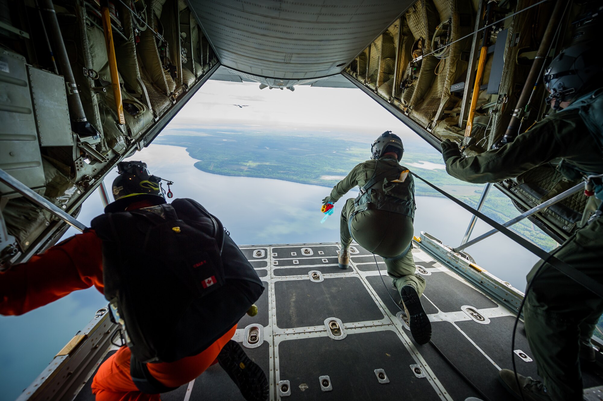 U.S. Air Force Staff Sgt. Patrick Englishby, C-130 Hercules loadmaster with the 914th Airlift Wing, Niagara Falls Air Reserve Station, N.Y., dispenses drift streamers during Maple Flag in Edmonton/Cold Lake, Alberta, Canada, June 3, 2014. Maple Flag is an international exercise designed to enhance the interoperability of C-130 aircrews, maintainers and support specialists in a simulated combat environment. (U.S. Air Force photo by Master Sgt. John R. Nimmo, Sr./Released)
