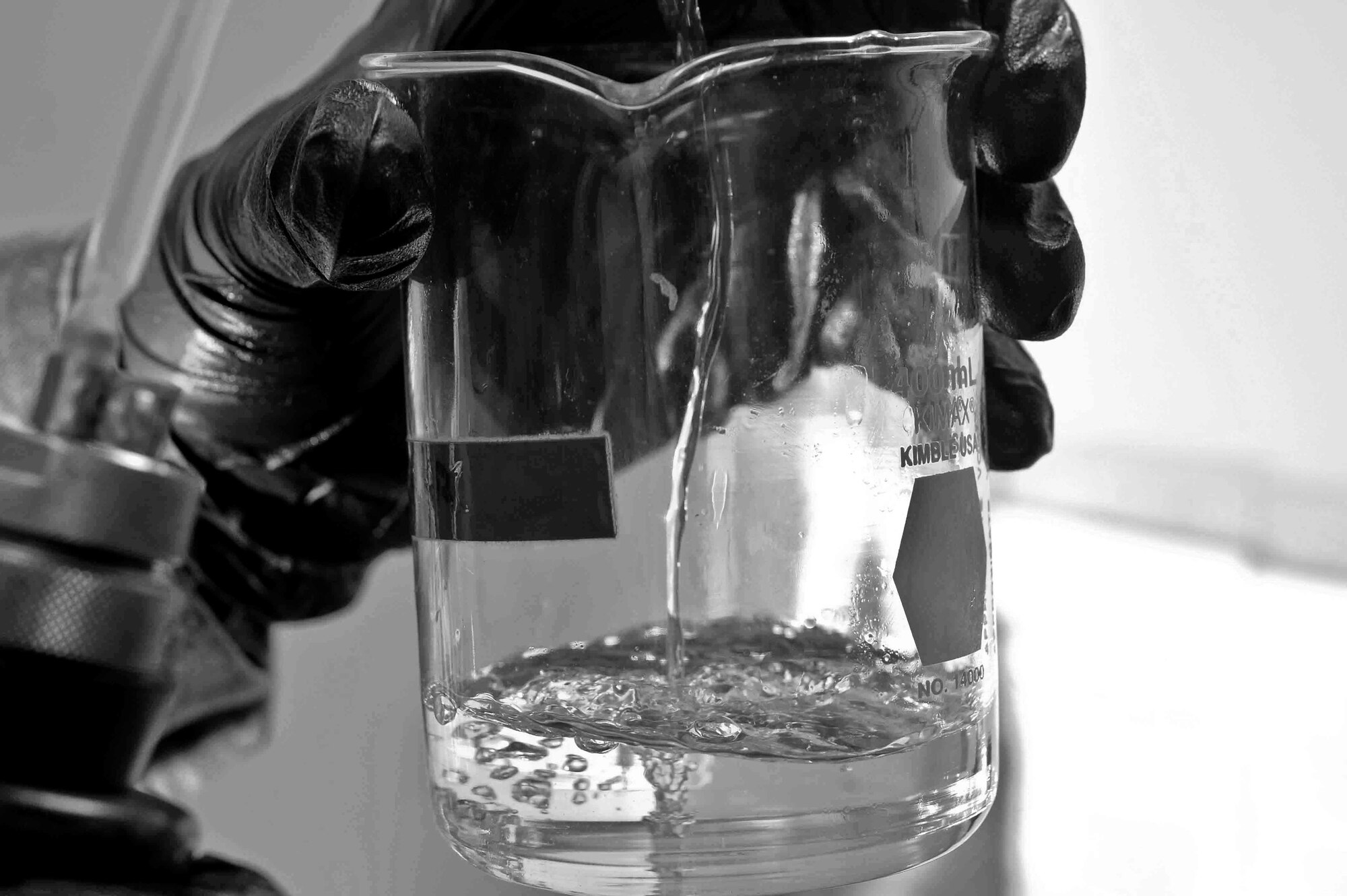 ALTUS AIR FORCE BASE, Okla. – U.S. Air Force Senior Airman Jordan Laughlin, 97th Logistics Readiness Squadron lab technician, pours fuel into a glass at the base fuel lab June 3, 2014. Fuels lab technicians provide clean, dry aviation and ground fuel to support the strategic airlift, aerial delivery and air refueling missions of Altus AFB. The fuels lab performs tests to rid the fuel of any foreign substances and ensure the highest quality product. (U.S. Air Force photo by Senior Airman Jesse Lopez/Released)