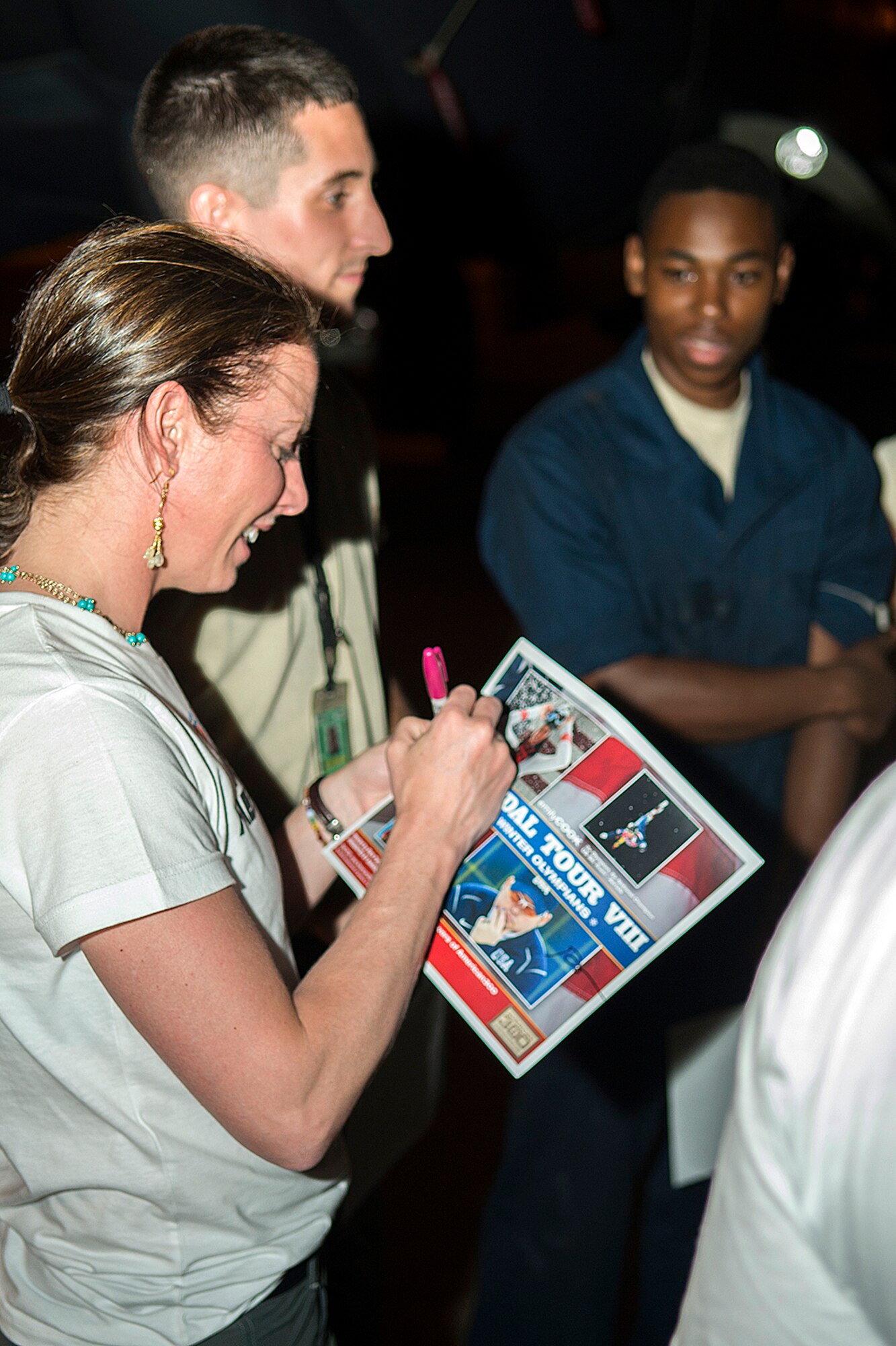 Emily Cook signs autographs after touring a 307th Bomb Wing B-52H Stratofortress, June 4, 2014, Barksdale Air Force Base, La. Cook is a 3-time Olympic U.S. Freestyle skier and joined the American300 Tours to visit military installations with the goal of increasing resiliency of the troops, their families, and the communities that they live and operate in. (U.S. Air Force photo by Master Sgt. Greg Steele/Released)