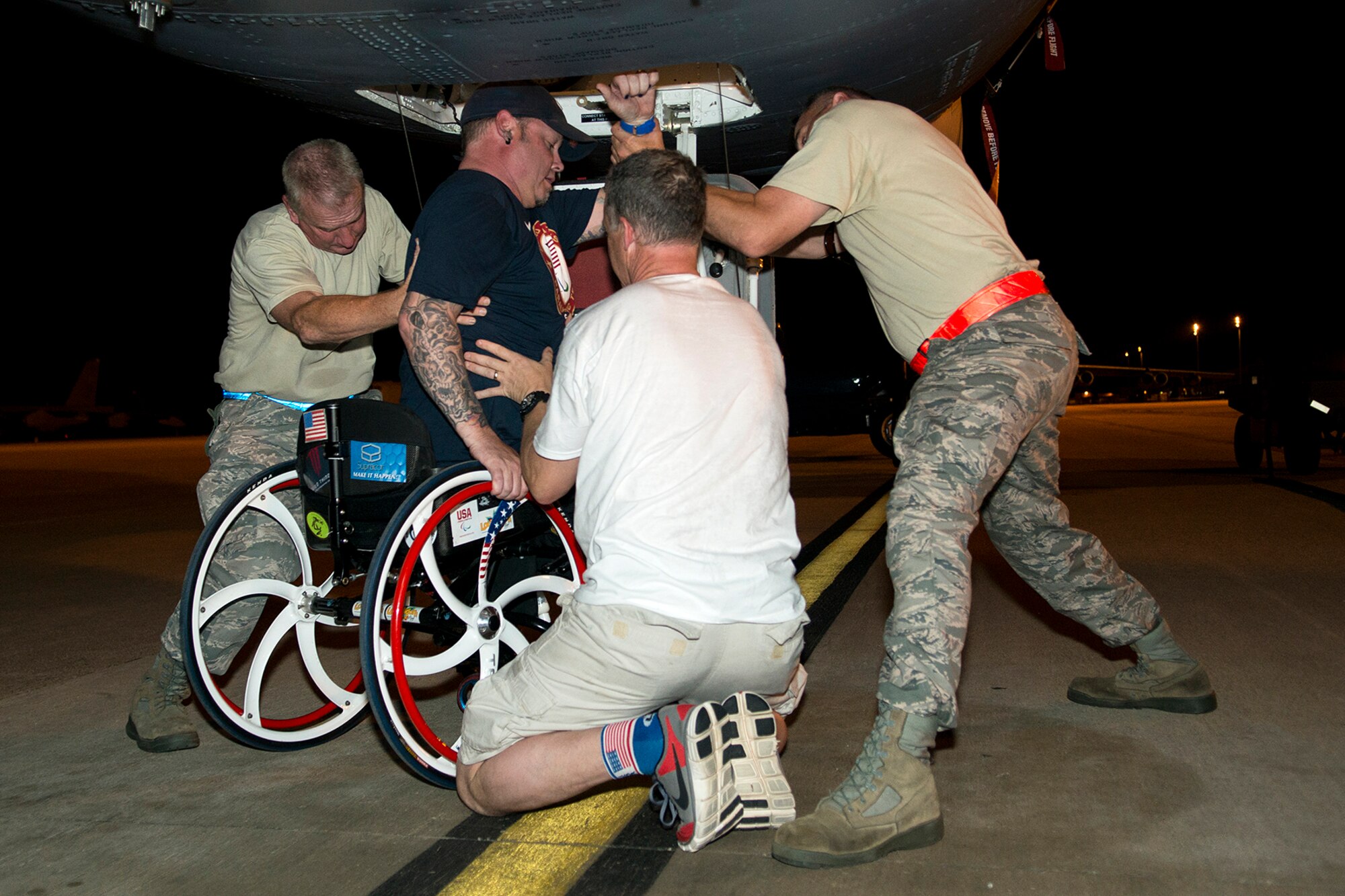 Patrick McDonald is helped down out of the cockpit of a 307th Bomb Wing B-52H Stratofortress during his visit to Barksdale Air Force Base, La., June 3, 2014. McDonald, a U.S. Army veteran, was paralyzed in 1991 as the result of an accident while serving with the Army in South Korea, joined the American300 Tours to share his experience with fellow military service members as part of the tour's 'Never Quit Series'. (U.S. Air Force photo by Master Sgt. Greg Steele/Released)