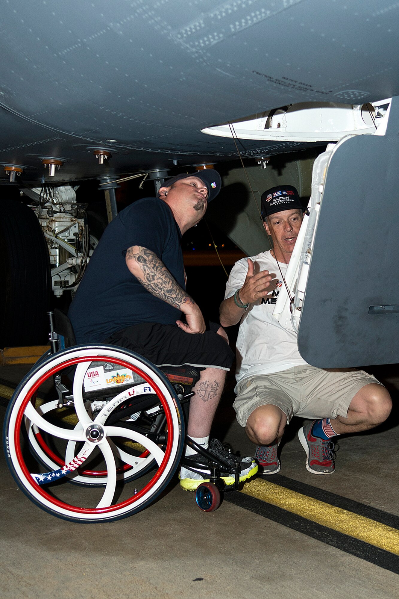 Patrick McDonald looks up the hatch of a 307th Bomb Wing B-52H Stratofortress before attempting to climb into the cockpit during a tour, June 4, 2014, Barksdale Air Force Base, La. McDonald, a U.S. Army veteran, was paralyzed in 1991 as the result of an accident while serving with the Army in South Korea, joined the American300 Tours to share his experience with fellow military service members as part of the tour's 'Never Quit Series'. (U.S. Air Force photo by Master Sgt. Greg Steele/Released)