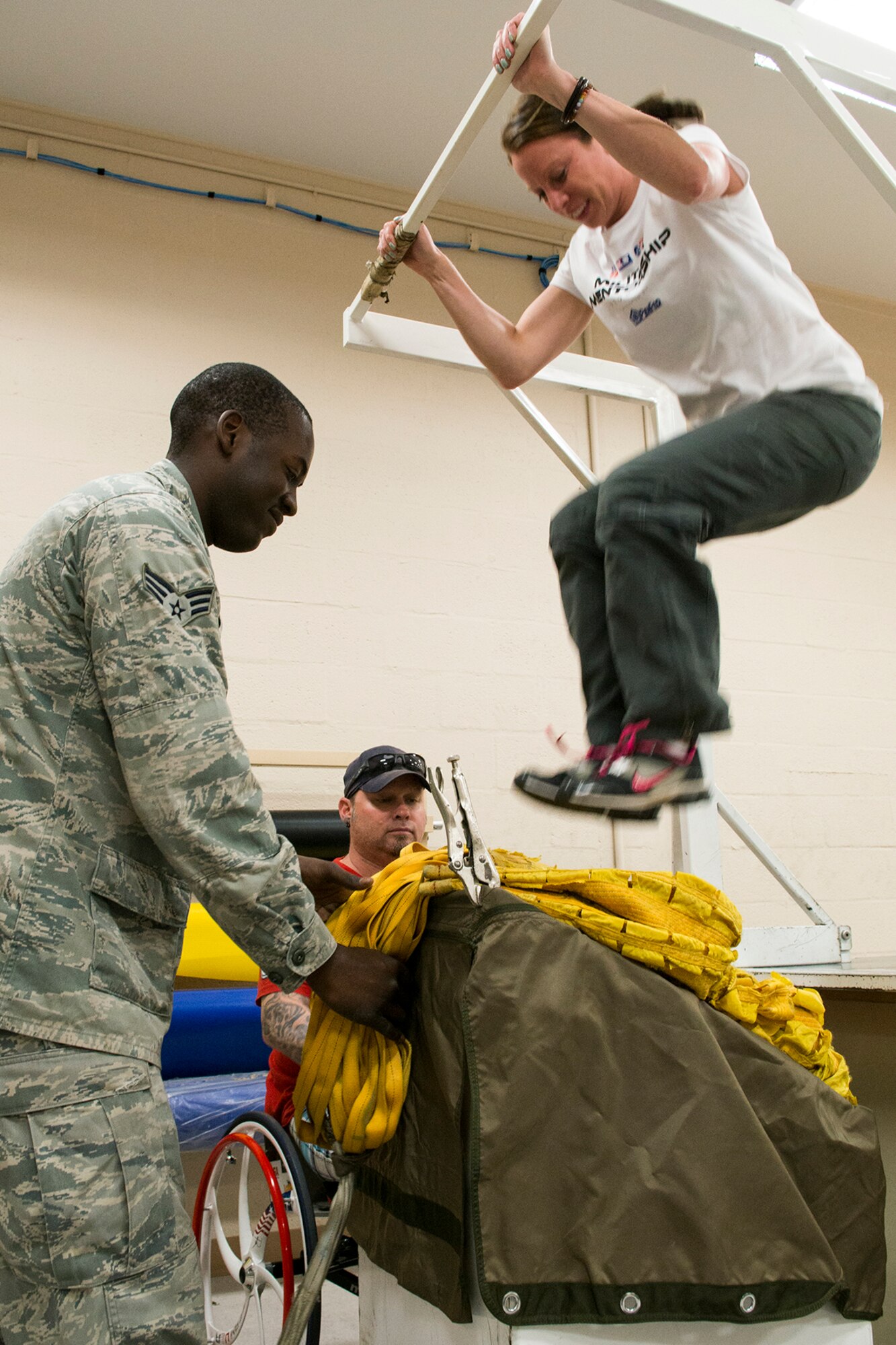 Emily Cook, a U.S. Olympic skier, tries to pack a B-52H Stratofortress drag chute during a tour of the 307th Operations Support Flight, June 4, 2014, Barksdale Air Force Base, La. Cook visited Barksdale with the American300 Tours to help connect servicemen and women with the people whose freedom they ensure. (U.S. Air Force photo by Master Sgt. Greg Steele/Released)