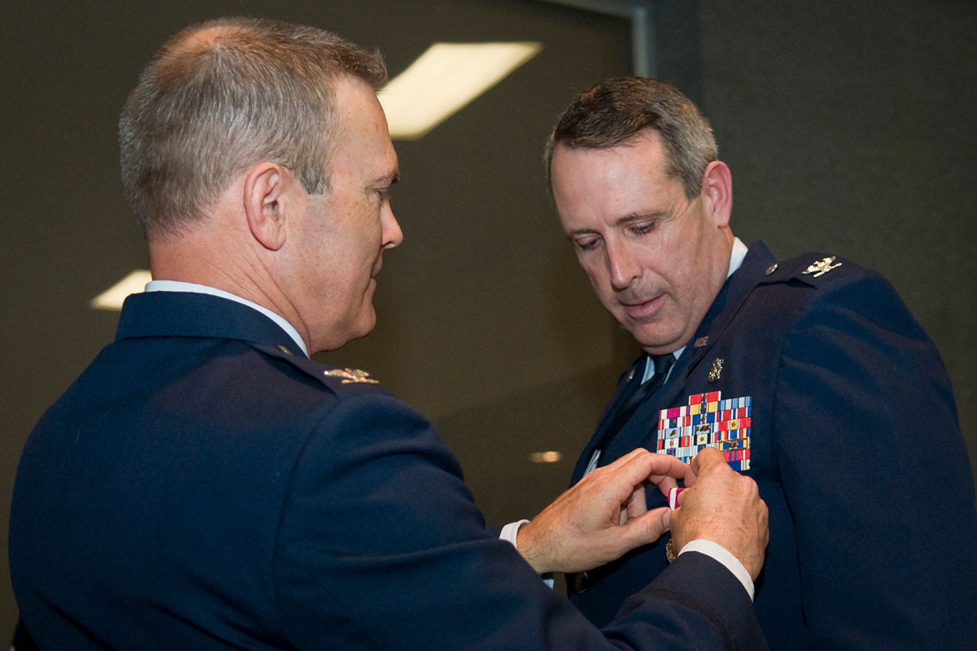 Retired Col. William Cahoon, a previous 434th Air Refueling Wing commander, pins a Meritorious Service Medal on Col. Thomas Collins, 434th Aerospace Medicine Squadron commander, at Grissom Air Reserve Base, Ind., April 13, 2014. Collins retired after serving nearly 38 years in both the regular Air Force and Air Force Reserve. (U.S. Air Force photo/Tech. Sgt. Mark R. W. Orders-Woempner)

